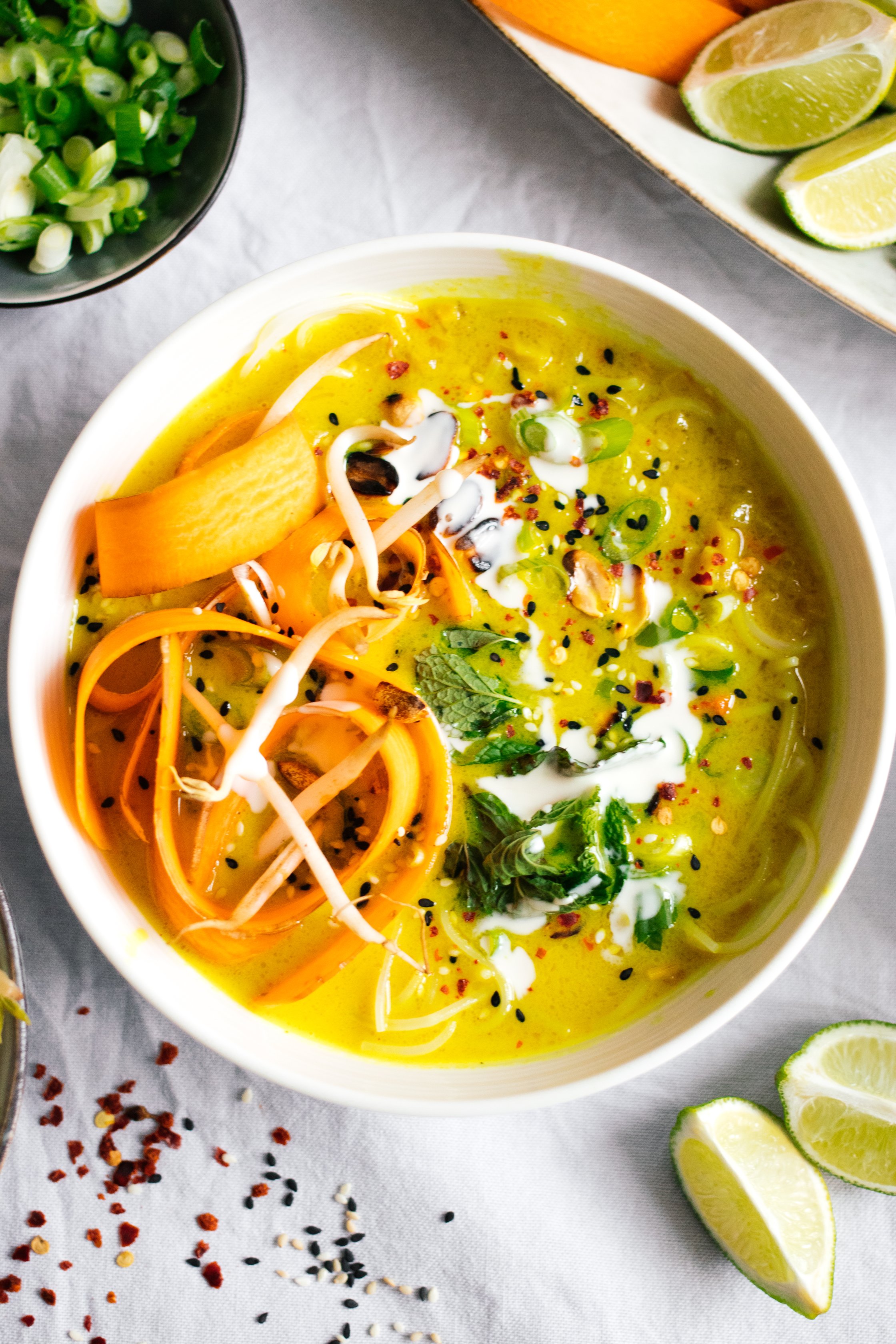 golden vegan coconut soup with rice noodles in a bowl