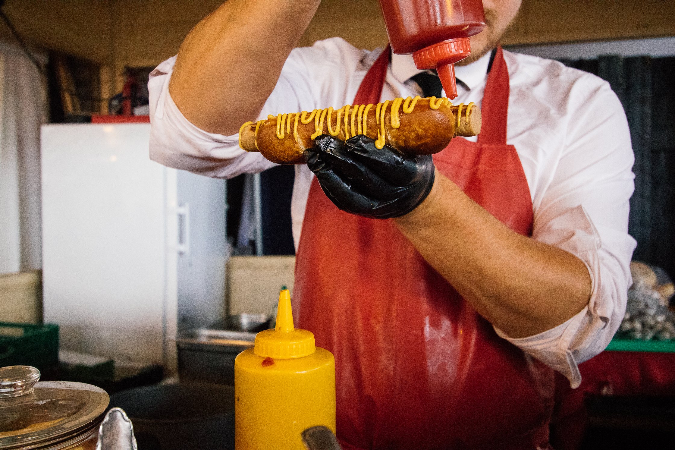 topping Hot Dogs with Ketchup