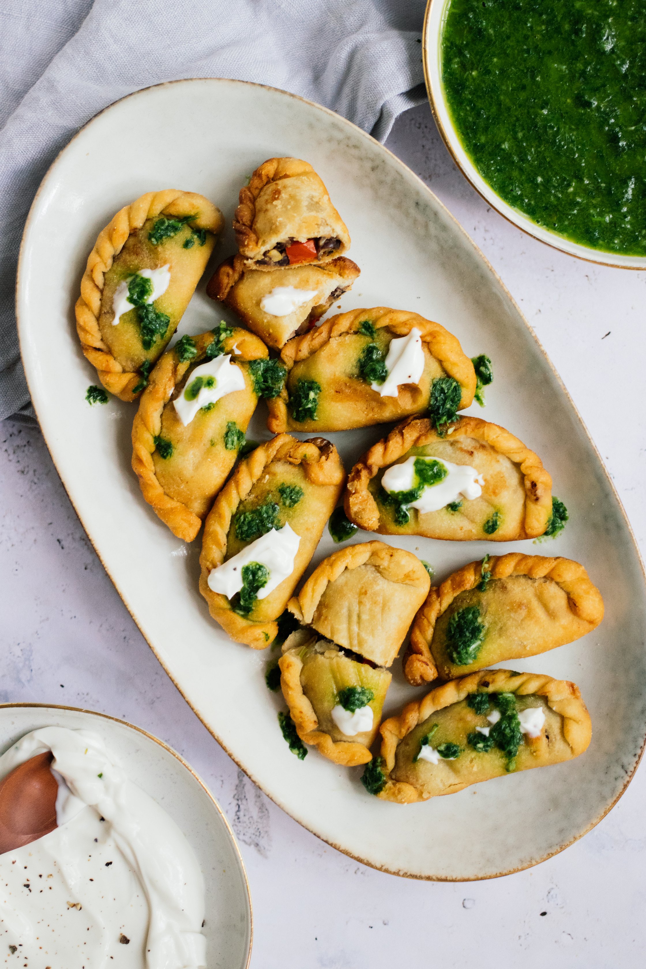 Vegan Empanadas with Vegetable Filling served with creme fraiche with green sauce