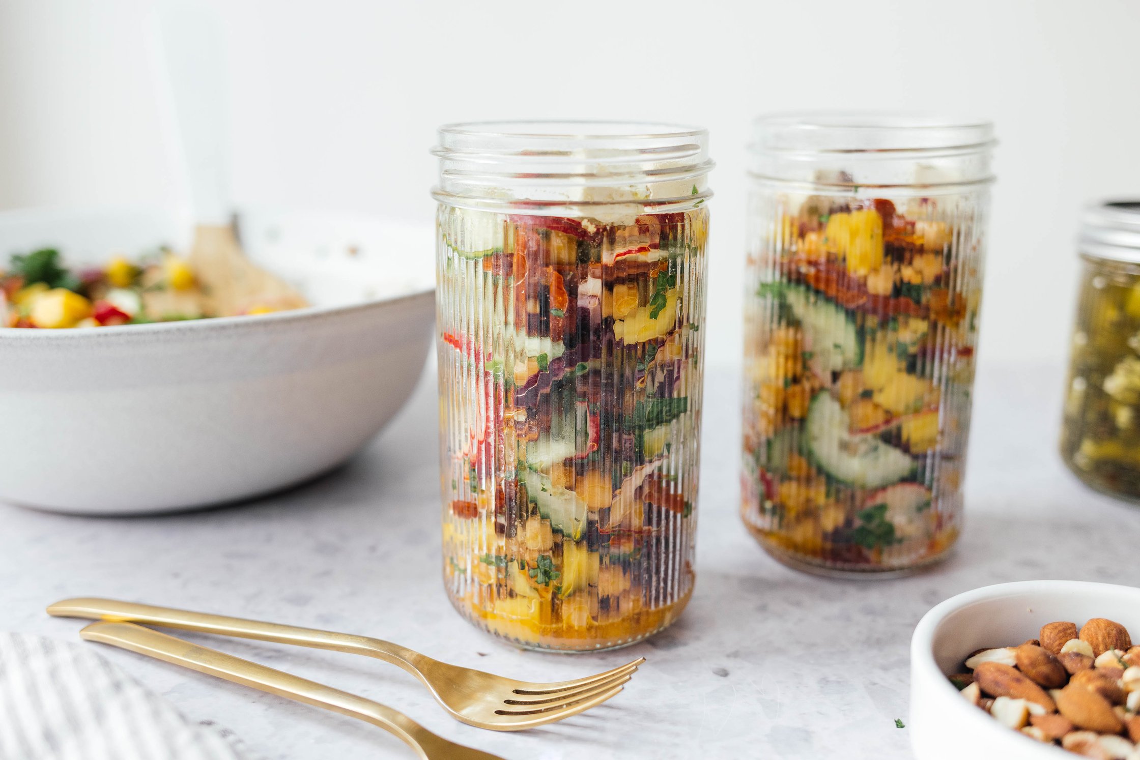 summer chickpea salad with vegan “feta heese“ filled in tall glasses