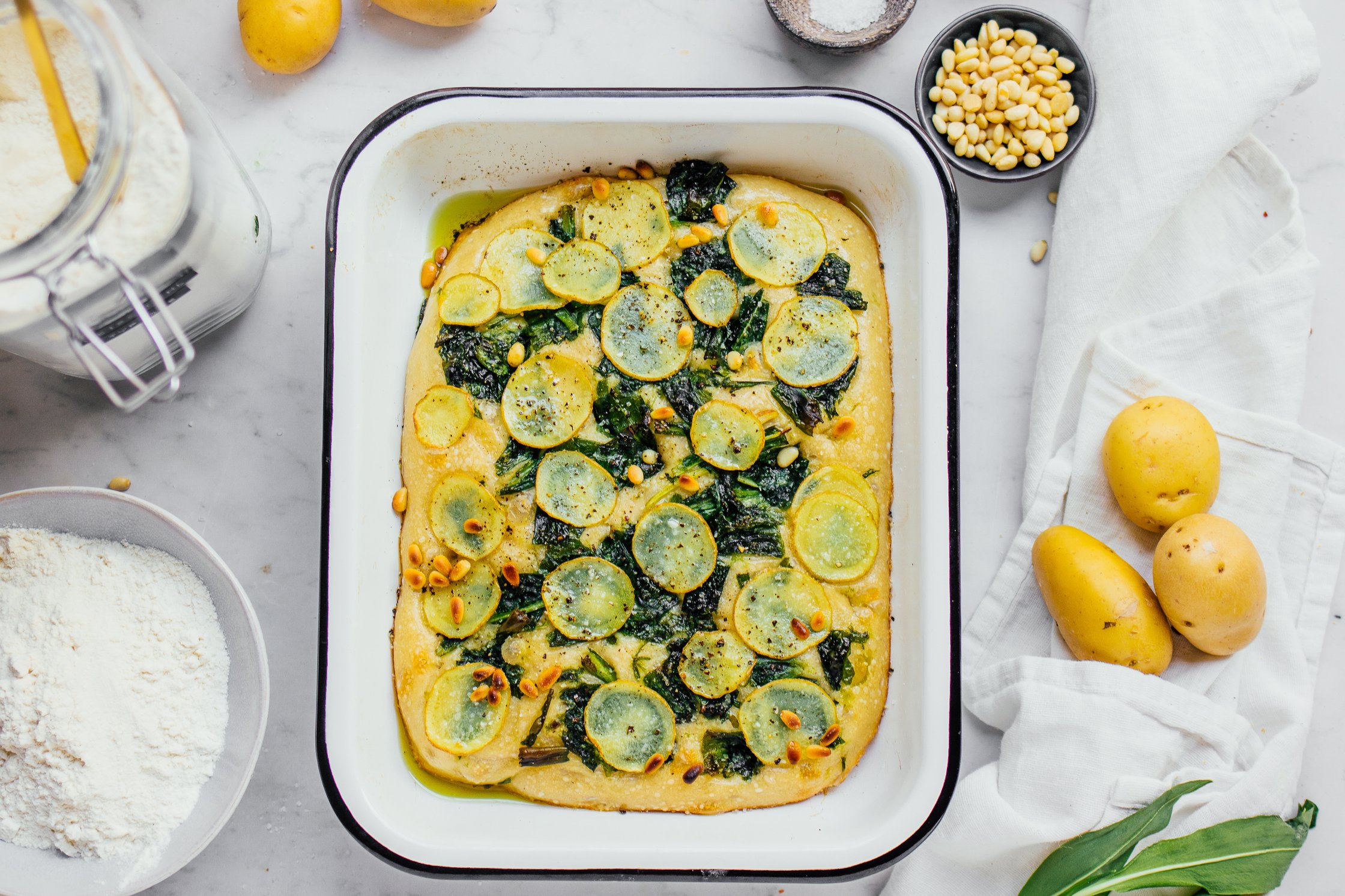 Freshly baked vegan wild garlic focaccia in baking tin