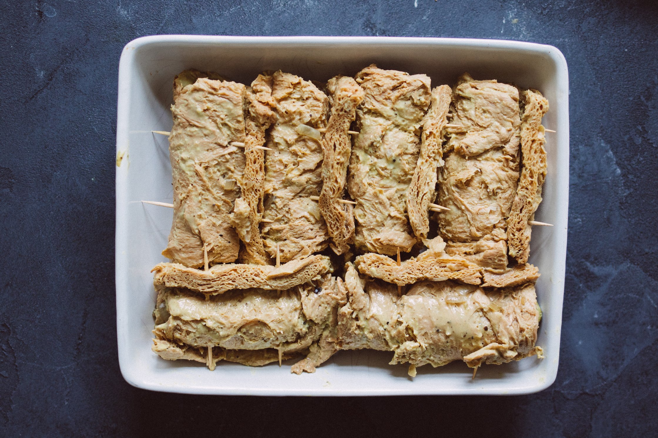 unbaked stuffed soy steaks in a casserole dish