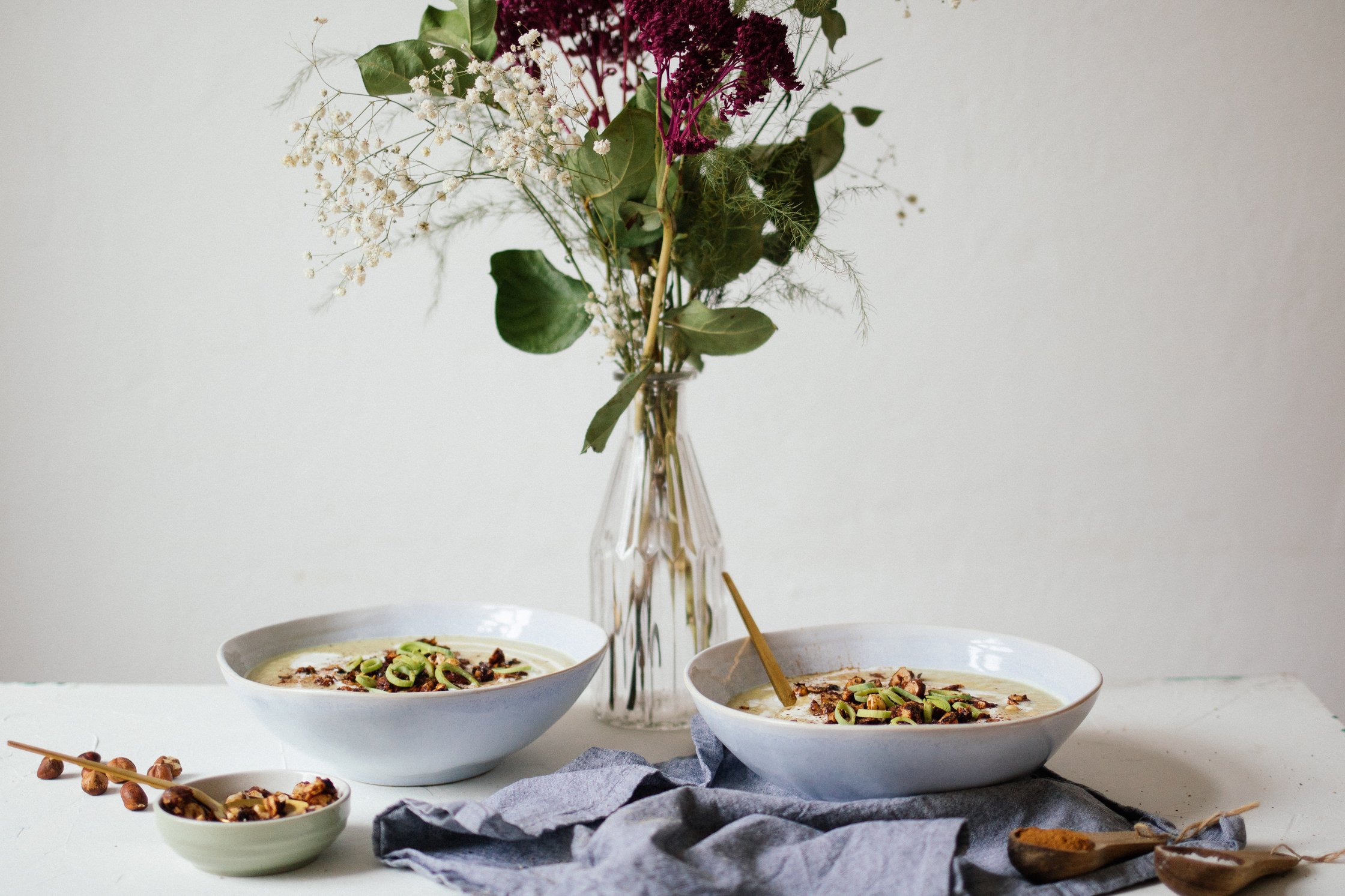 cauliflower soup next to fresh flowers