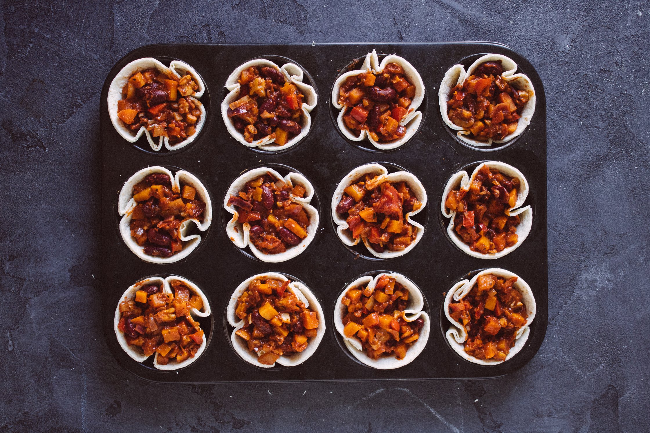filled taco cups before baking