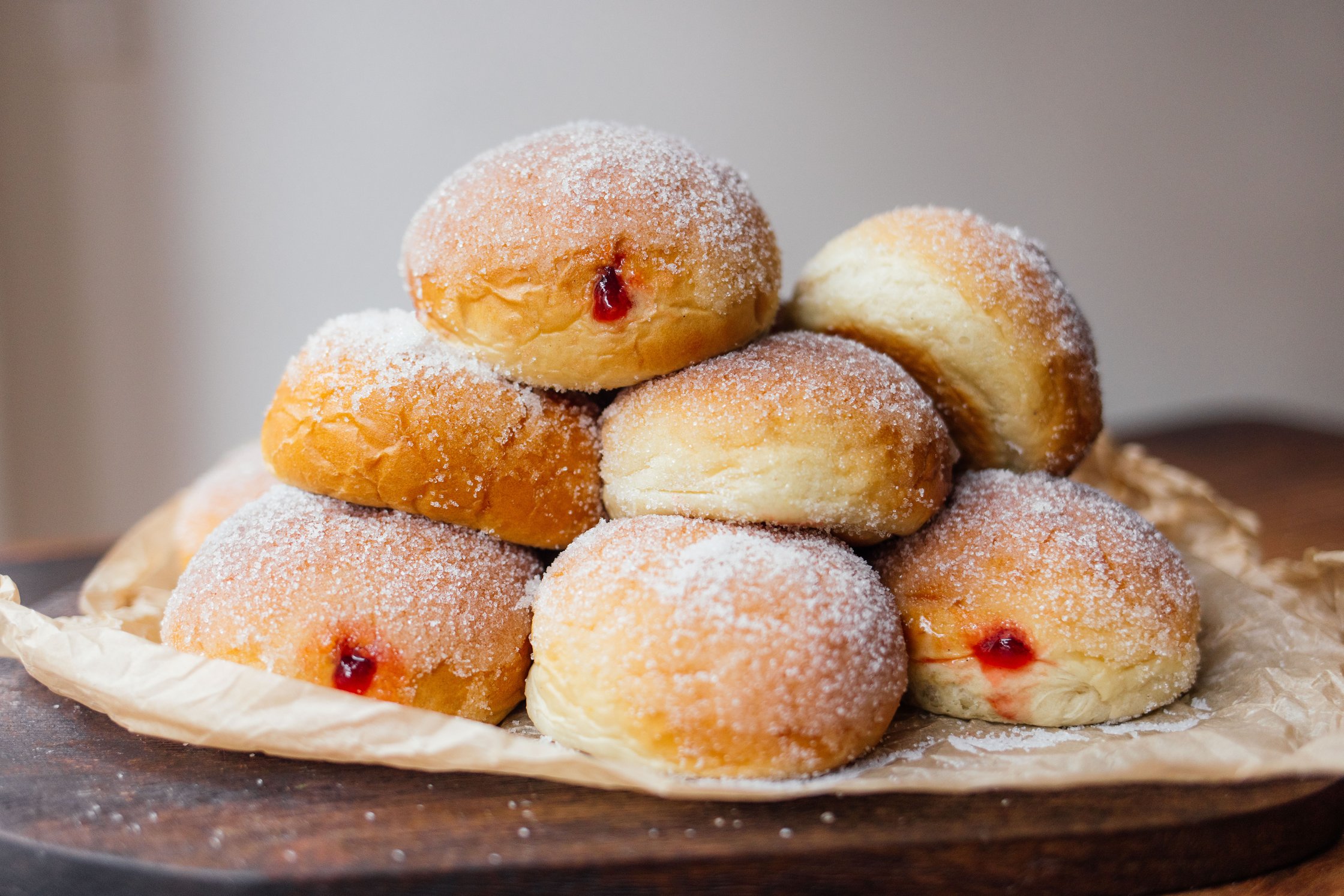 vegan doughnuts from the oven stacked on a board