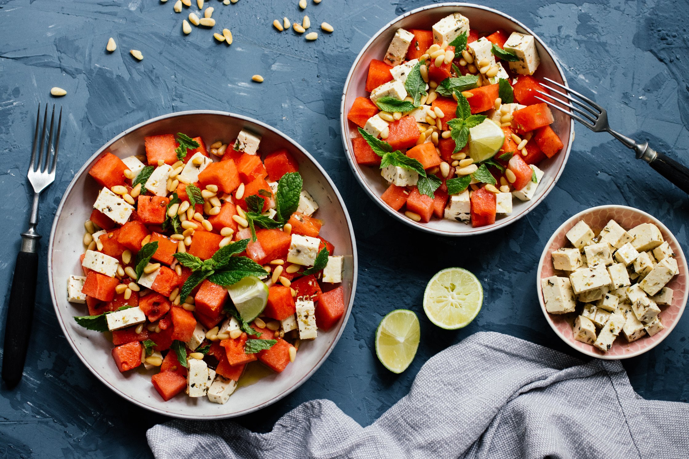 Vegan watermelon & feta salad on a blue backdrop