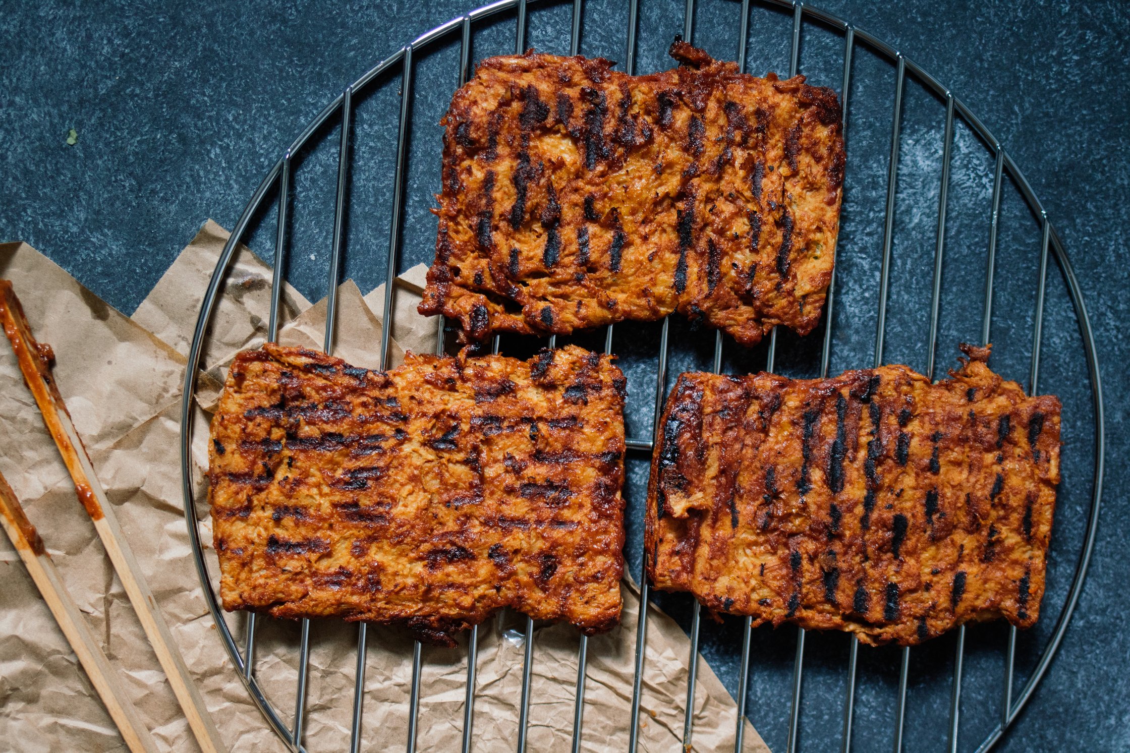 grilled soy steaks on cooking grate