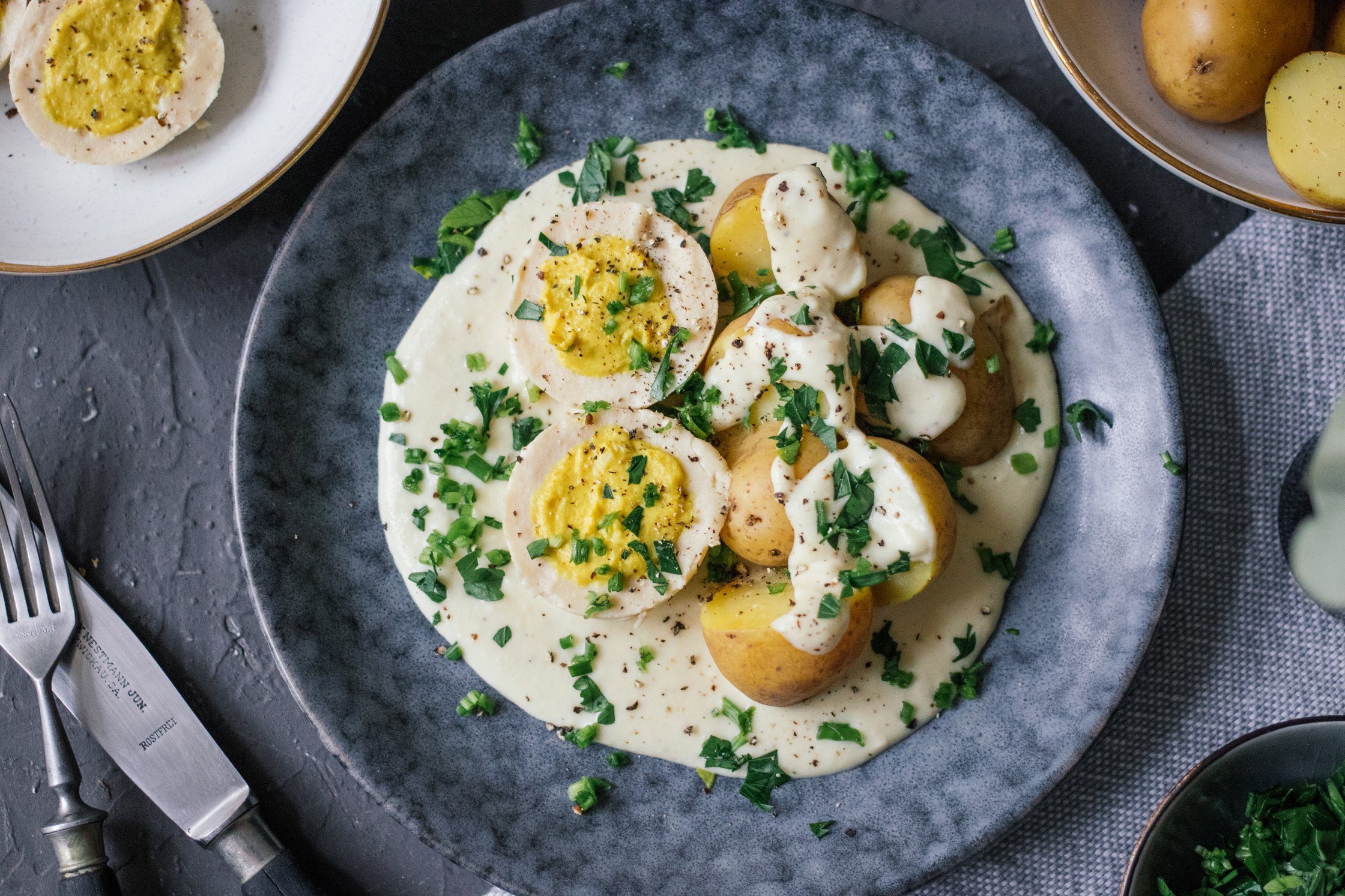 topshot of Vegan Boiled Eggs in Creamy Mustard Sauce with Potatoes