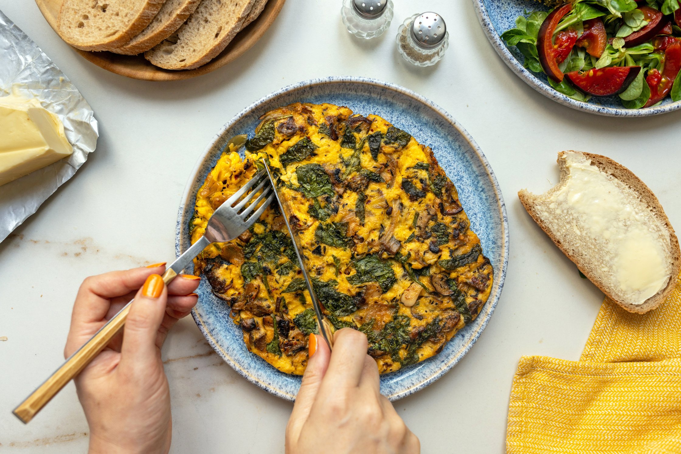 A top-down shot of a set table, with the vegan omelet in the center.