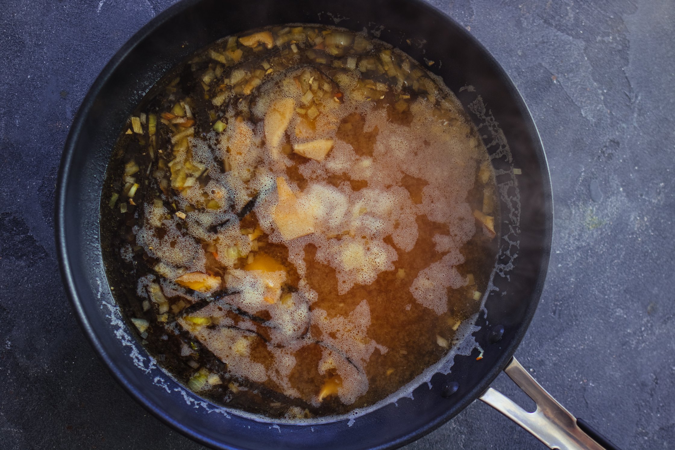 preparing the broth made of shiitake mushrooms for a vegan ramen soup