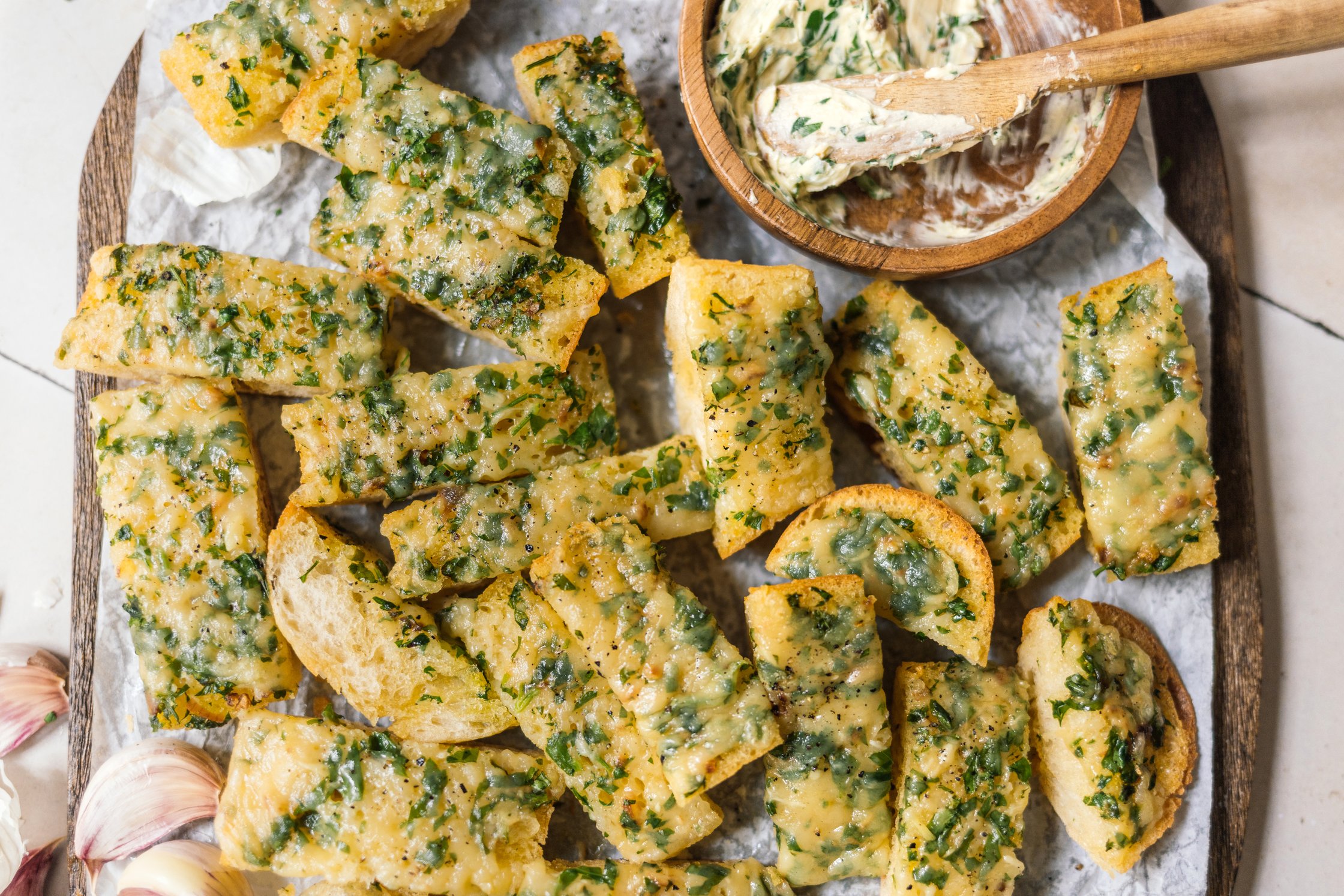 vegan herb and cheese baguette cut in stripes