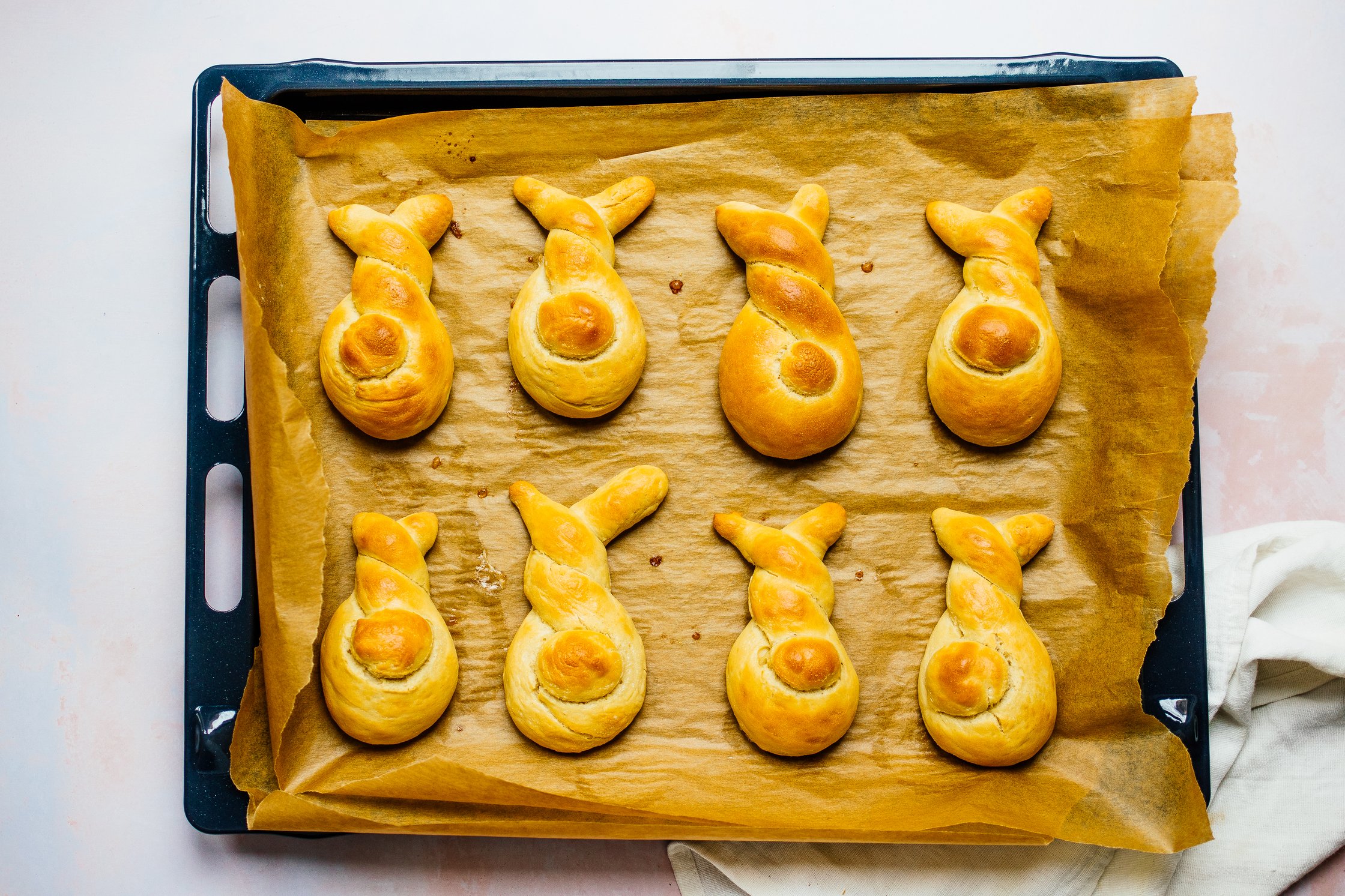 vegan easter bunny rolls on a baking tray after baking
