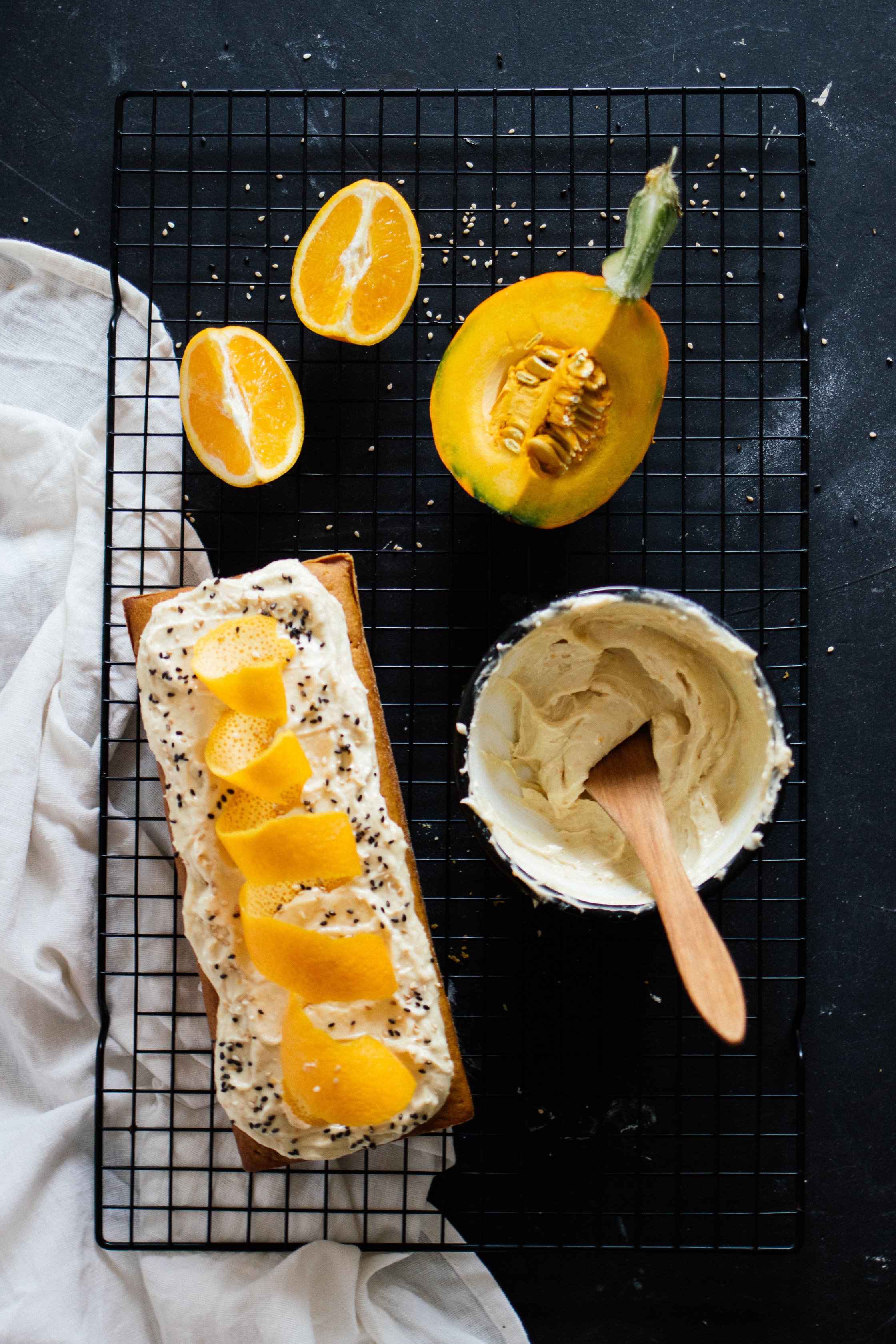 vegan pumpkin cake with orange and tahini on a cooling rack