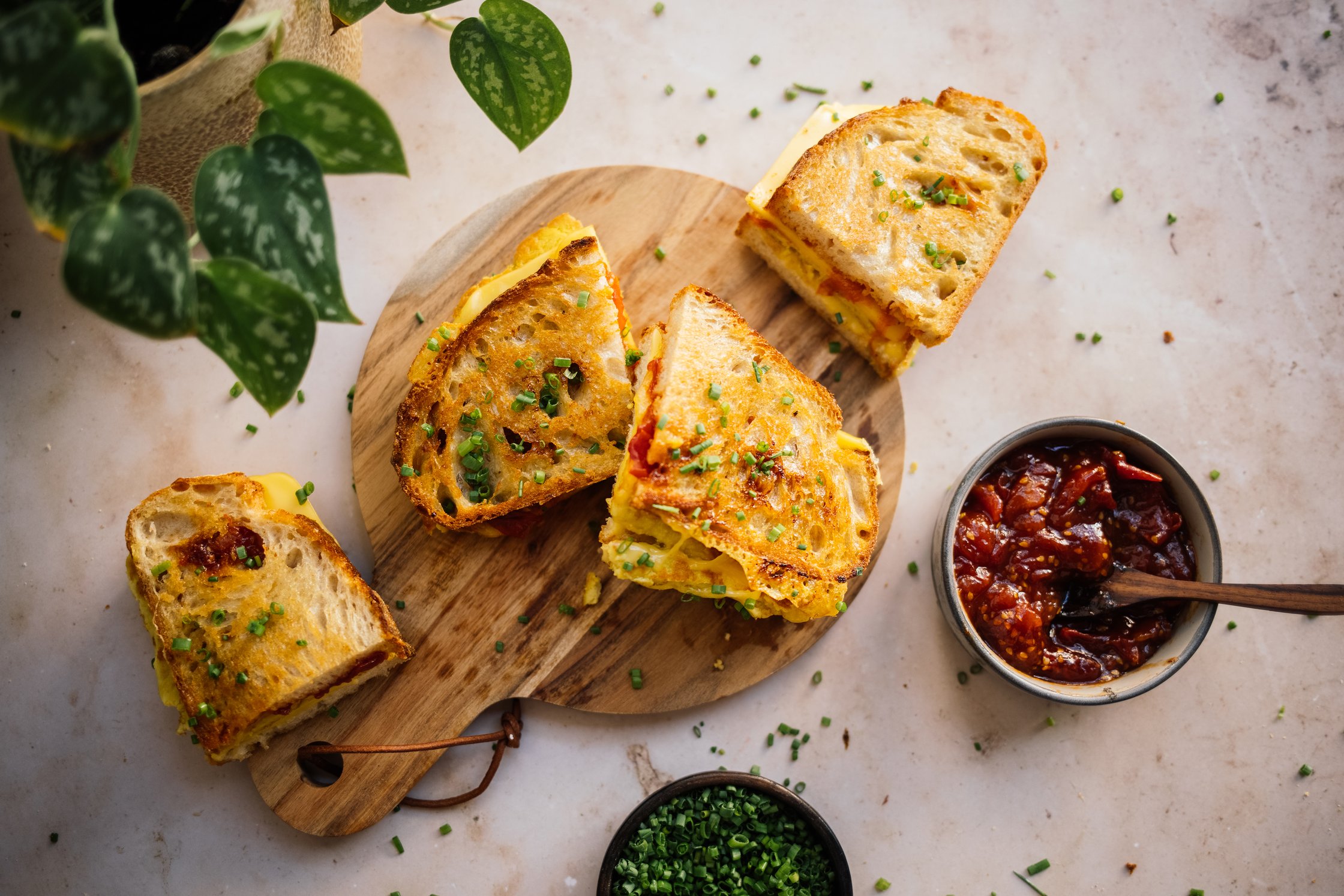 Vegan Breakfast Grilled Cheese with Tomato Jam on a wooden plate