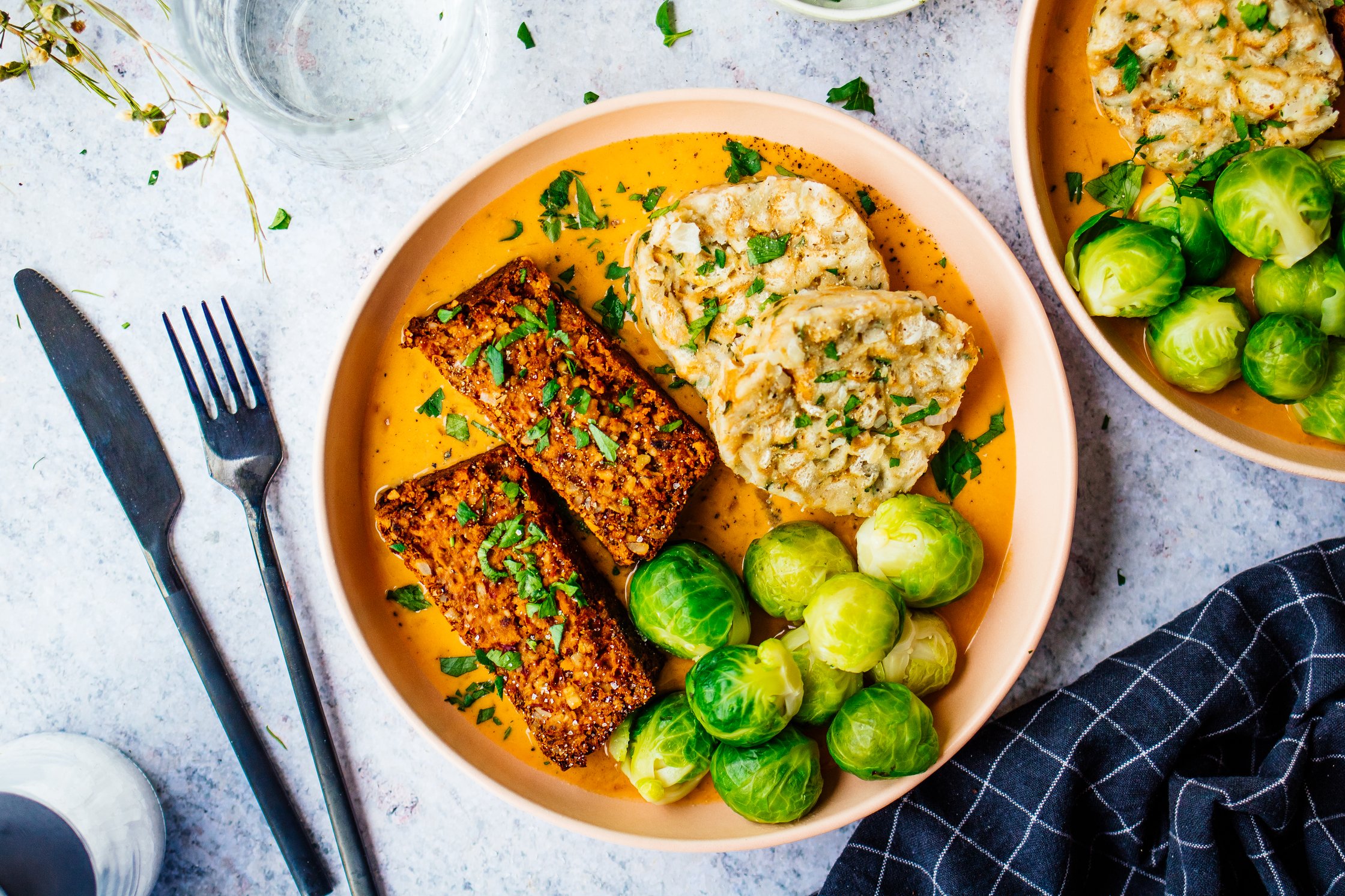 vegan nut roast with cream sauce, brussels sprouts, and bread dumplings