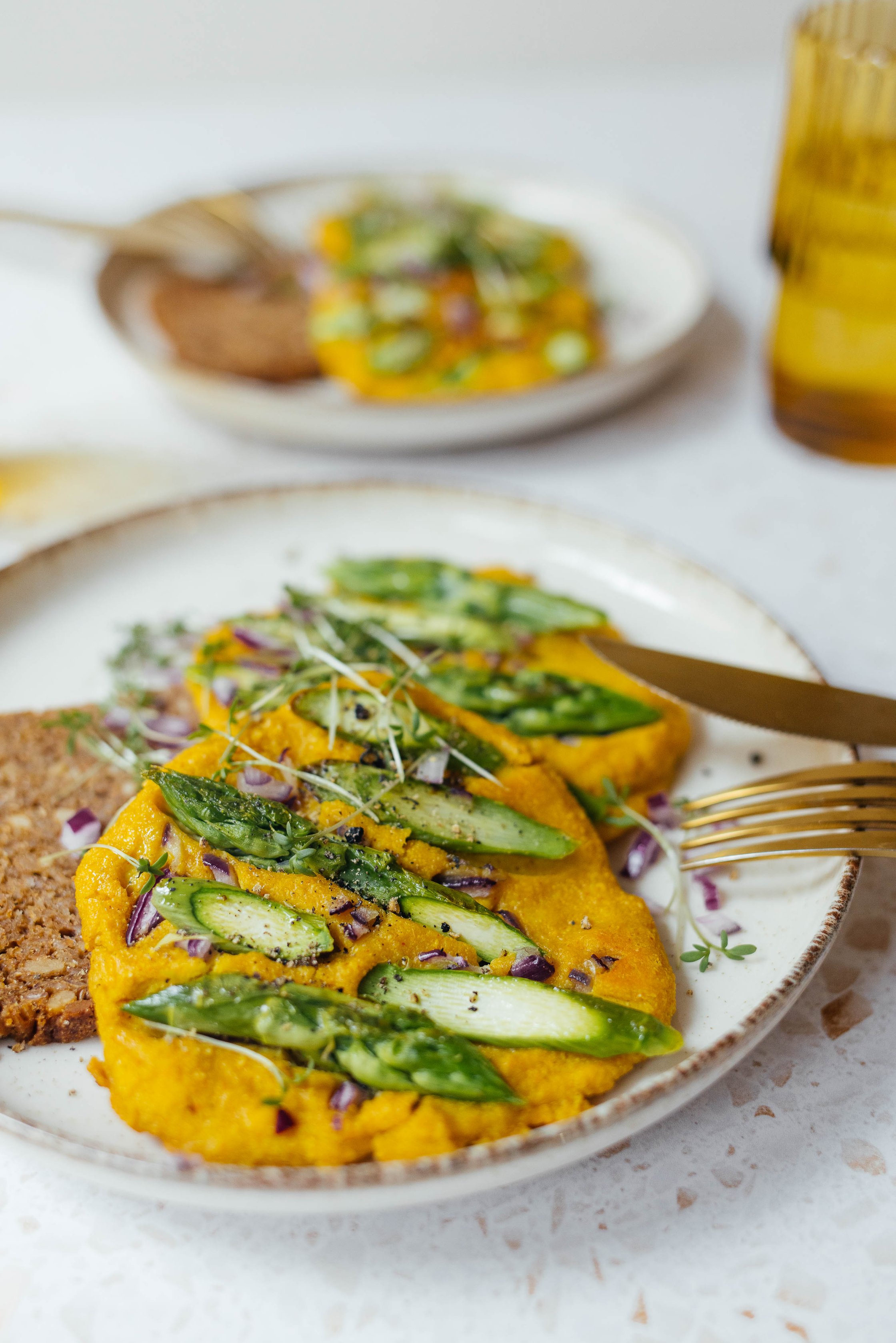 vegan silken tofu omelet with green asparagus served with whole grain bread