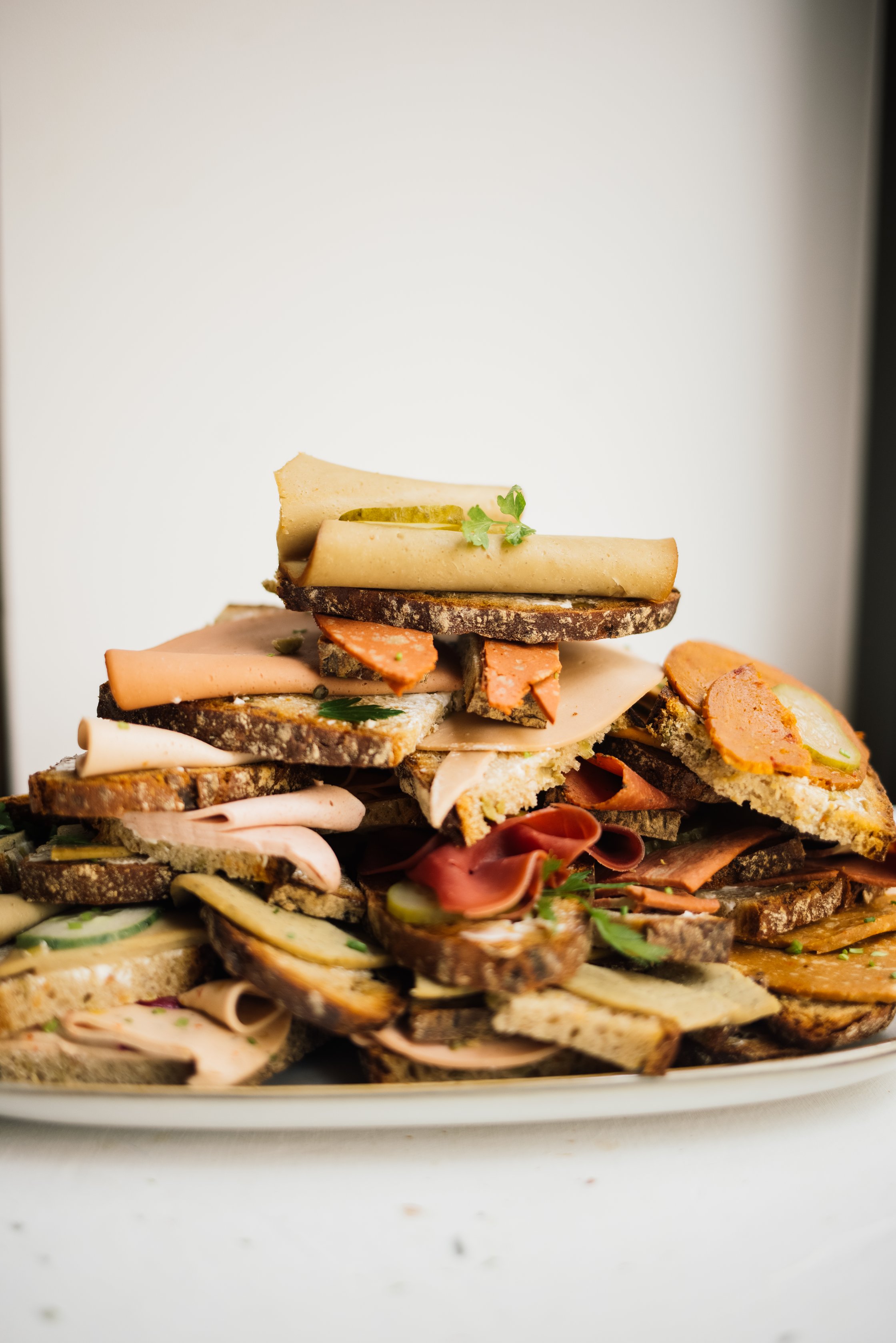 a pile of sandwiches with vegan cold cuts