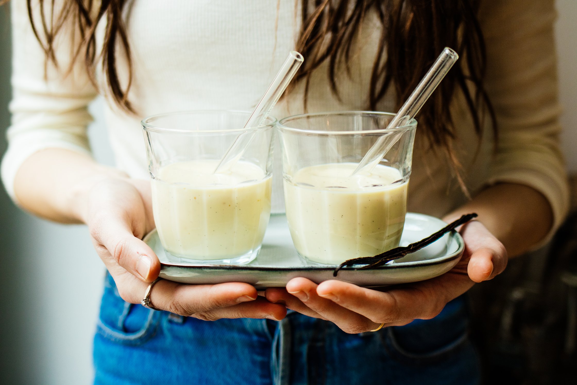 ein Mädchen hält zwei Gläser veganen Eierlikör