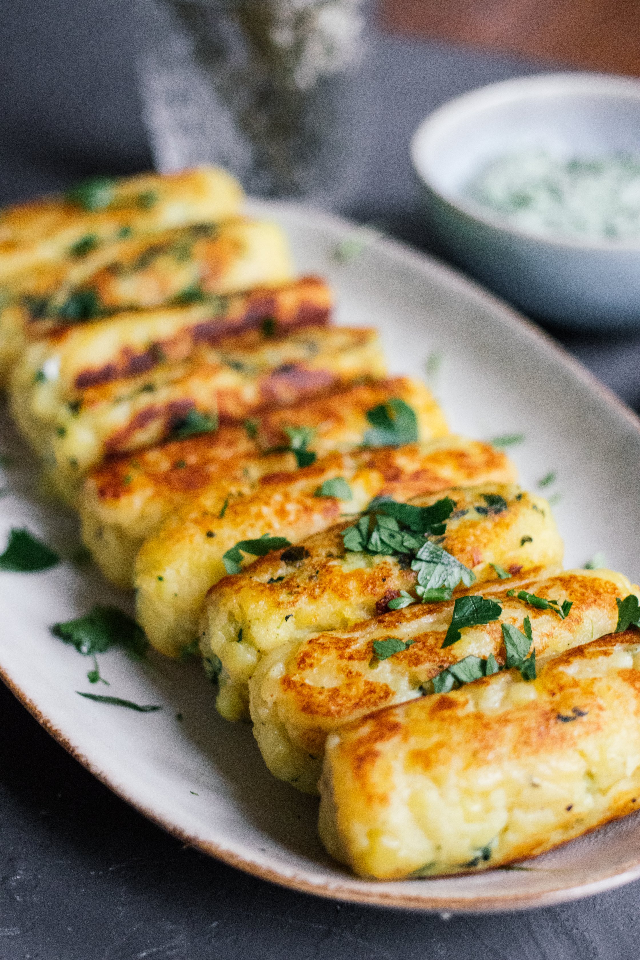 vegan potato cakes are lined up on a plate