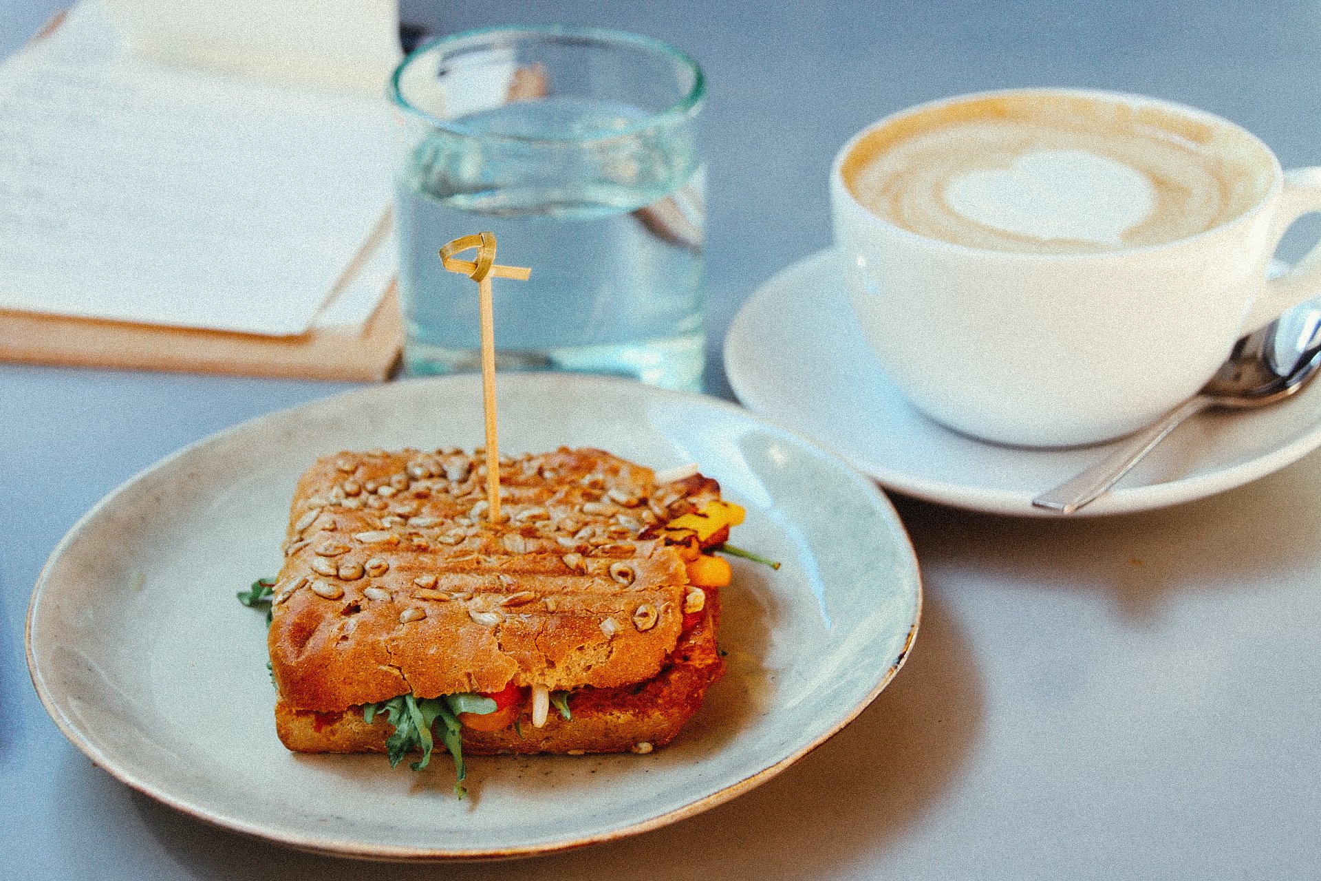 a sandwich and a coffee on a table