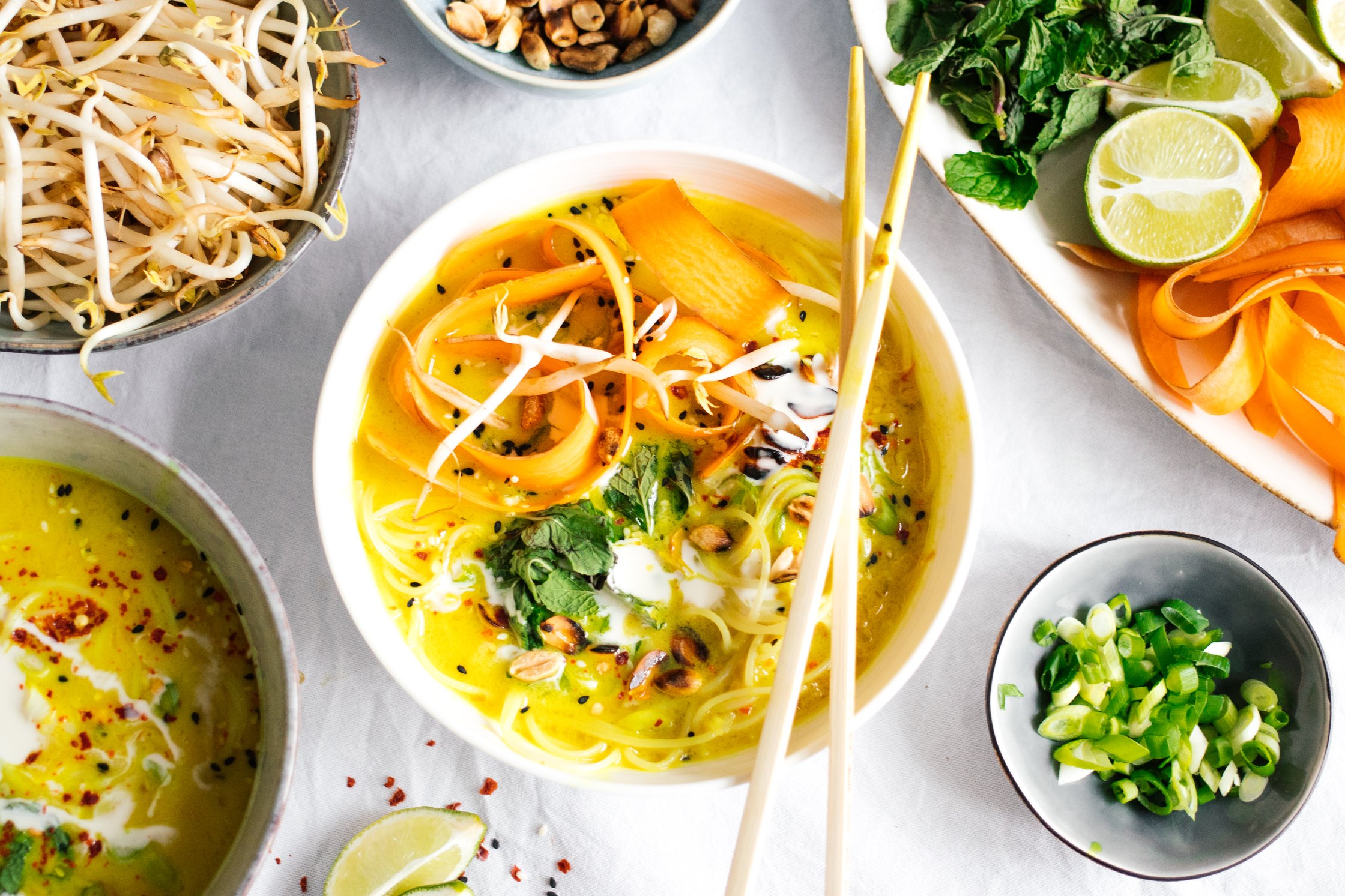 golden coconut soup with rice noodles and toppings