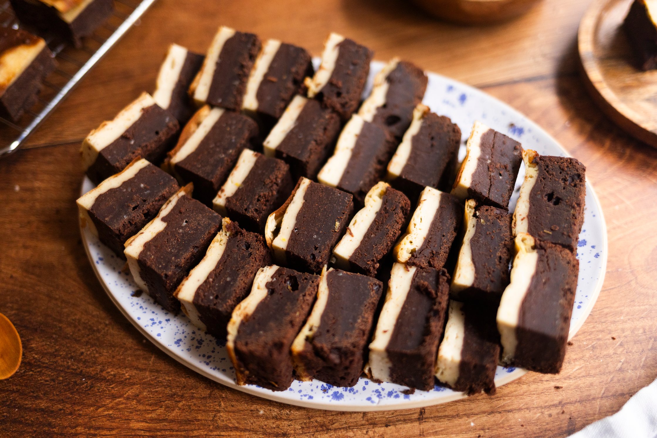 vegan cheesecake brownies placed on a white platter