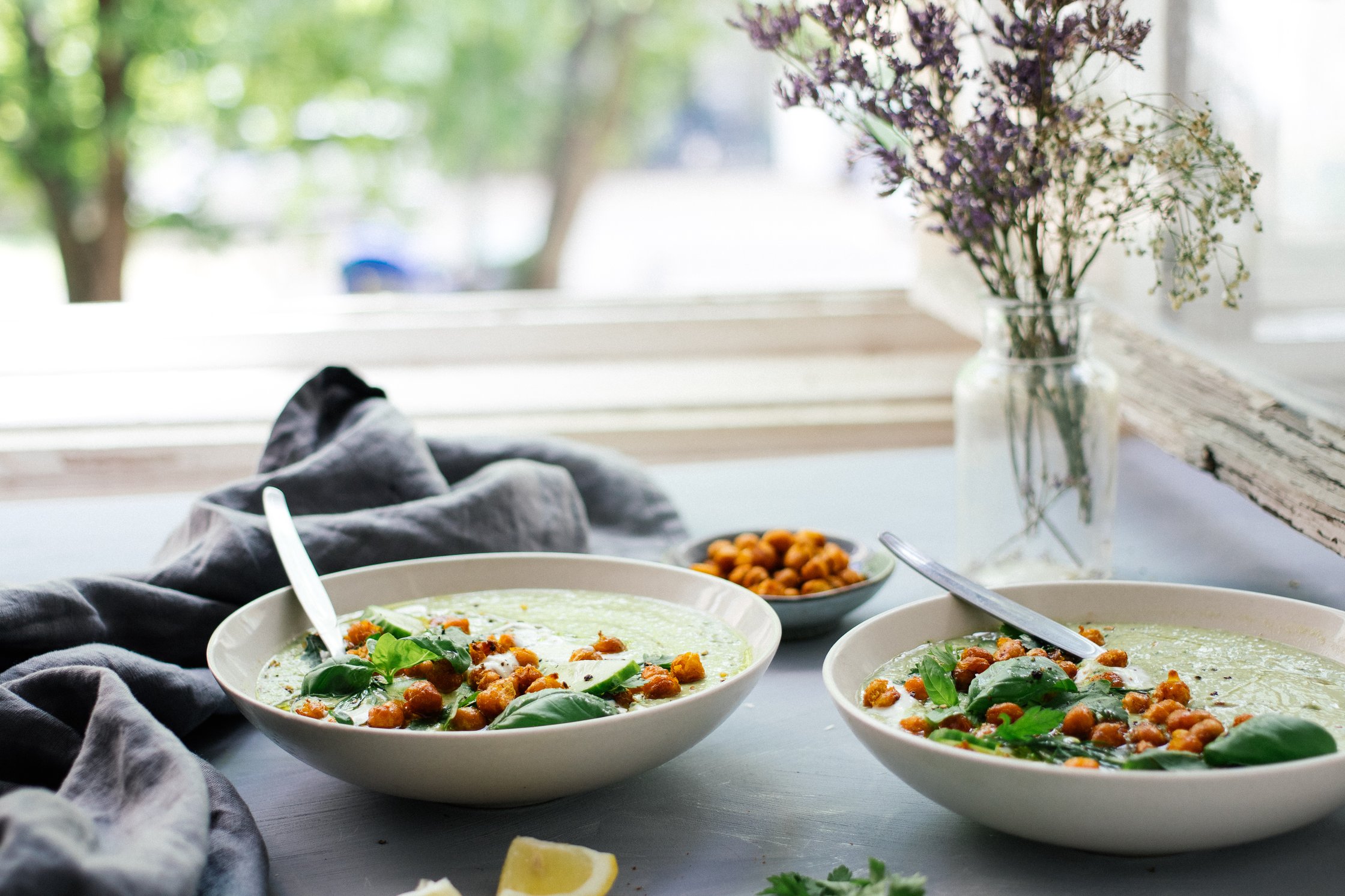 two plates with cucumber soup, ready to eat