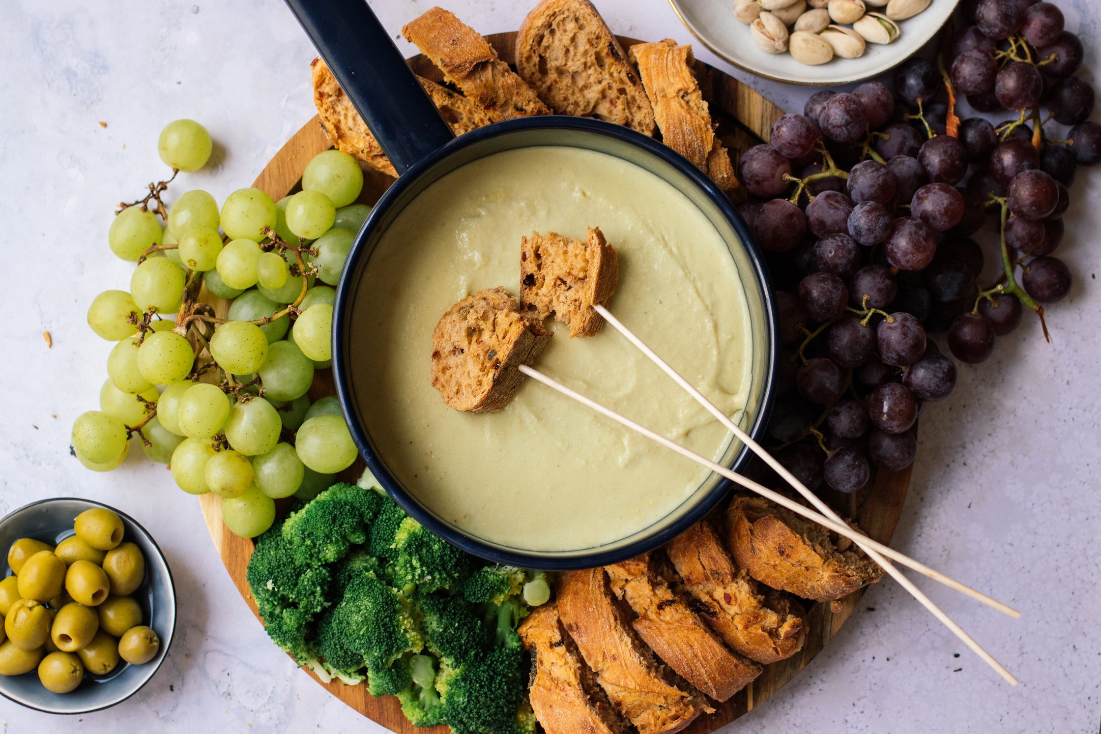 vegan cheese fondue with bread on skewers