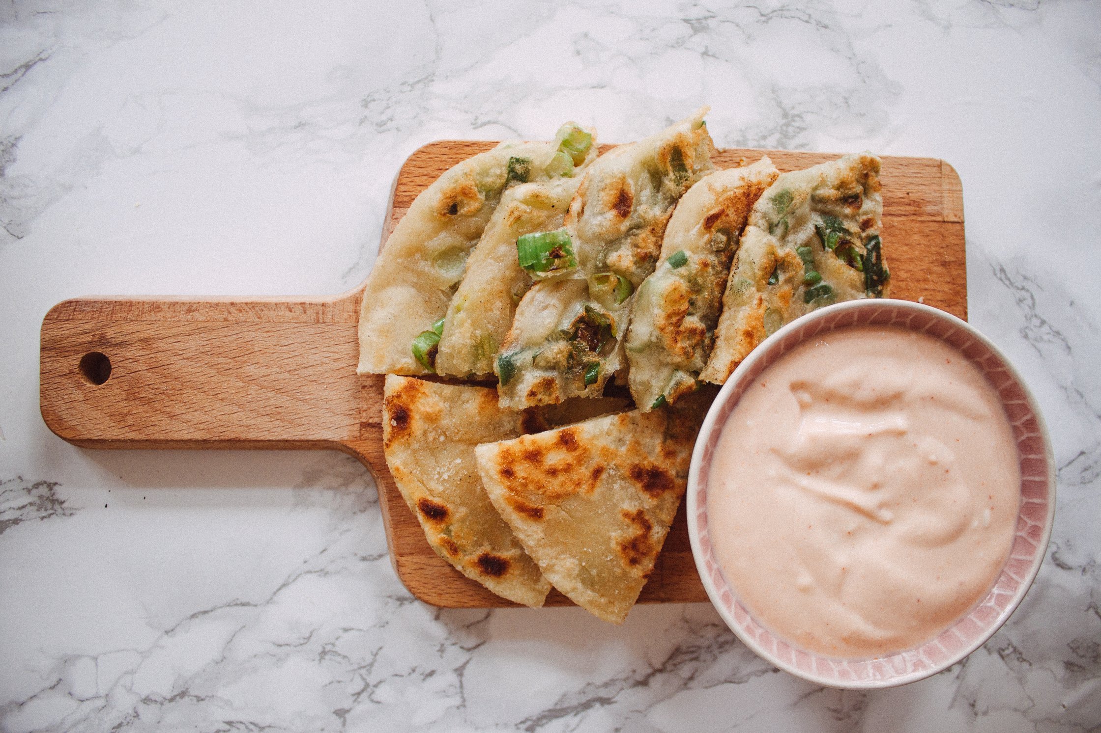 pancakes on a wooden cutting board with dip