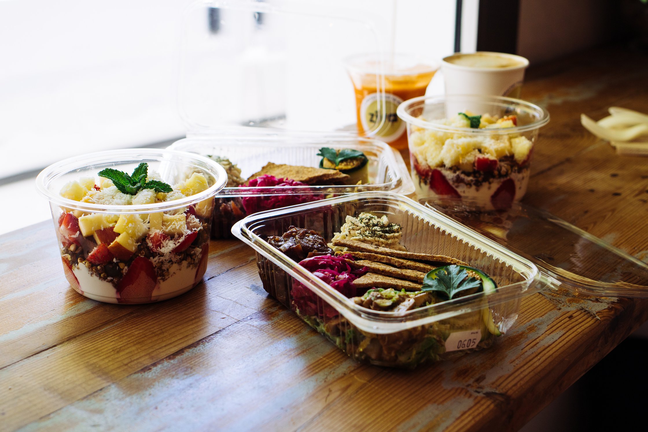a lot of plastic cups with food