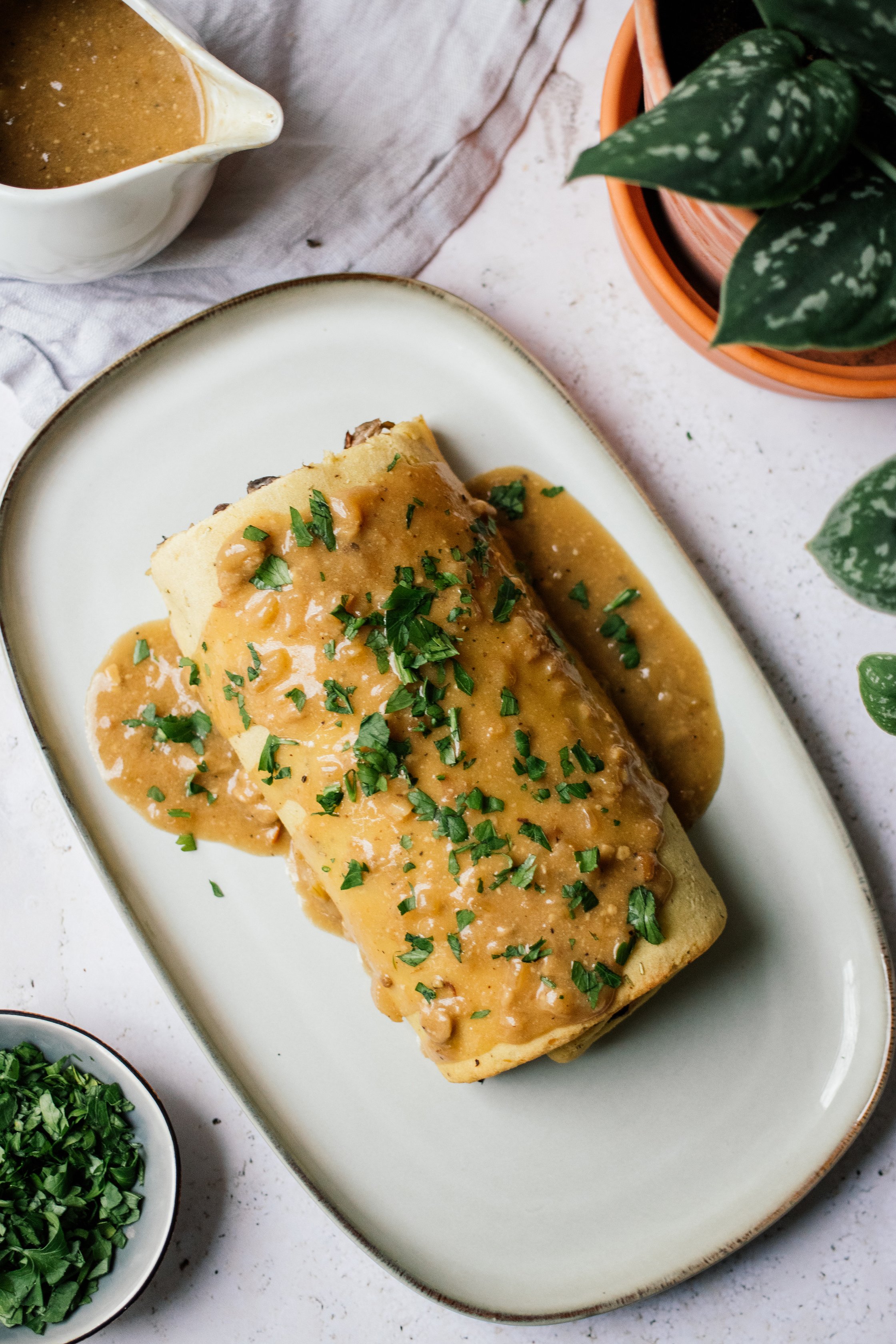 Vegan Potato Roll with Mushroom and Nut Filling and Vegan Cream Sauce on a plate