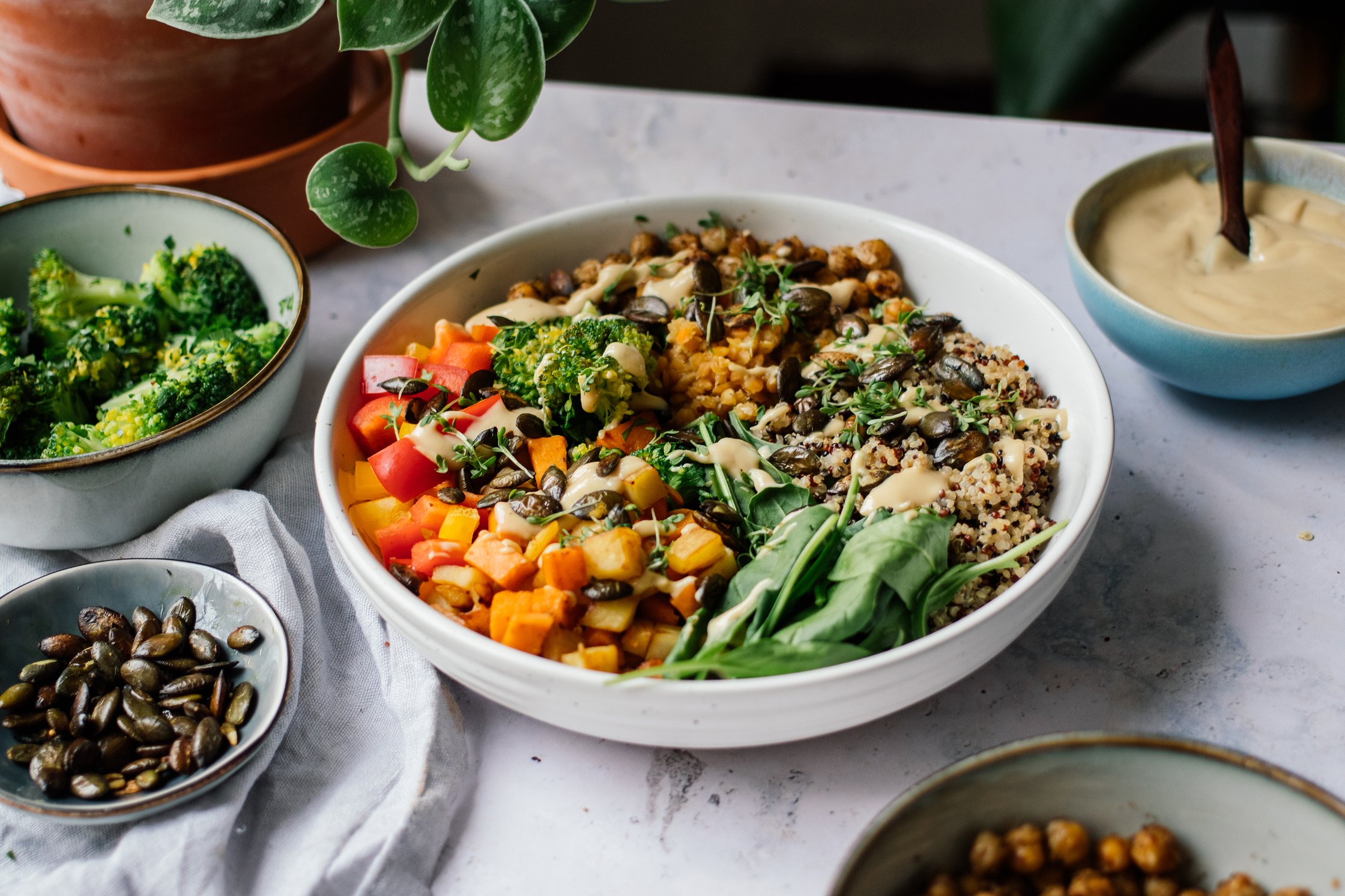 Veggie Bowl with Quinoa, Lentils, Sesame Dressing, and Crispy Chickpeas on the table