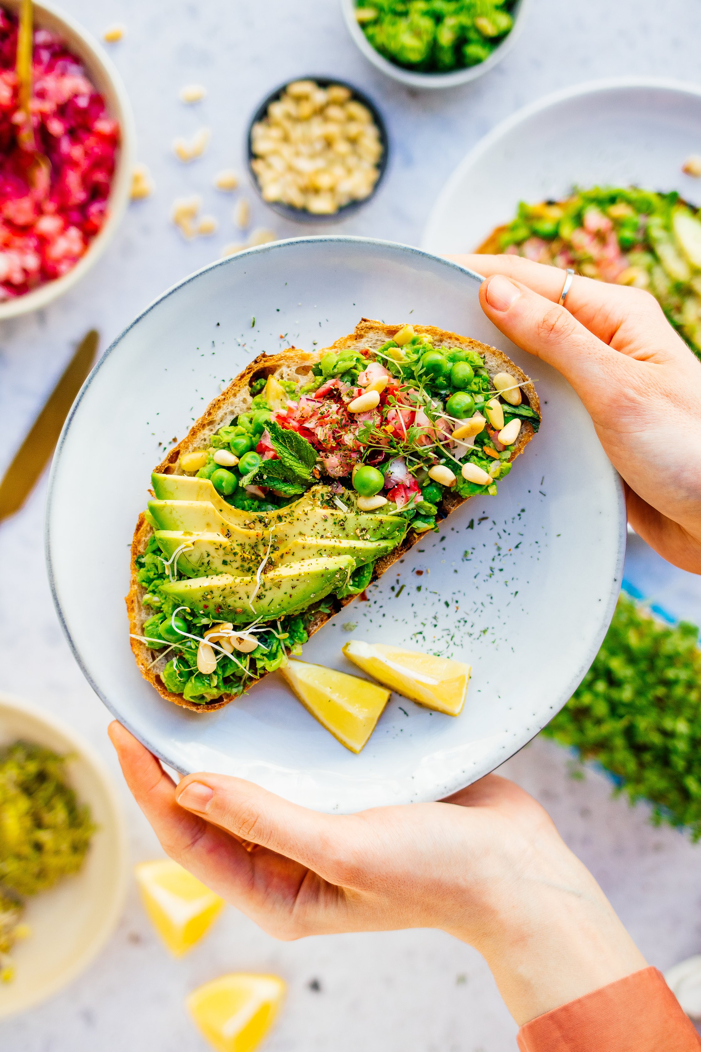 a plate with a sandwich topped with peacamole