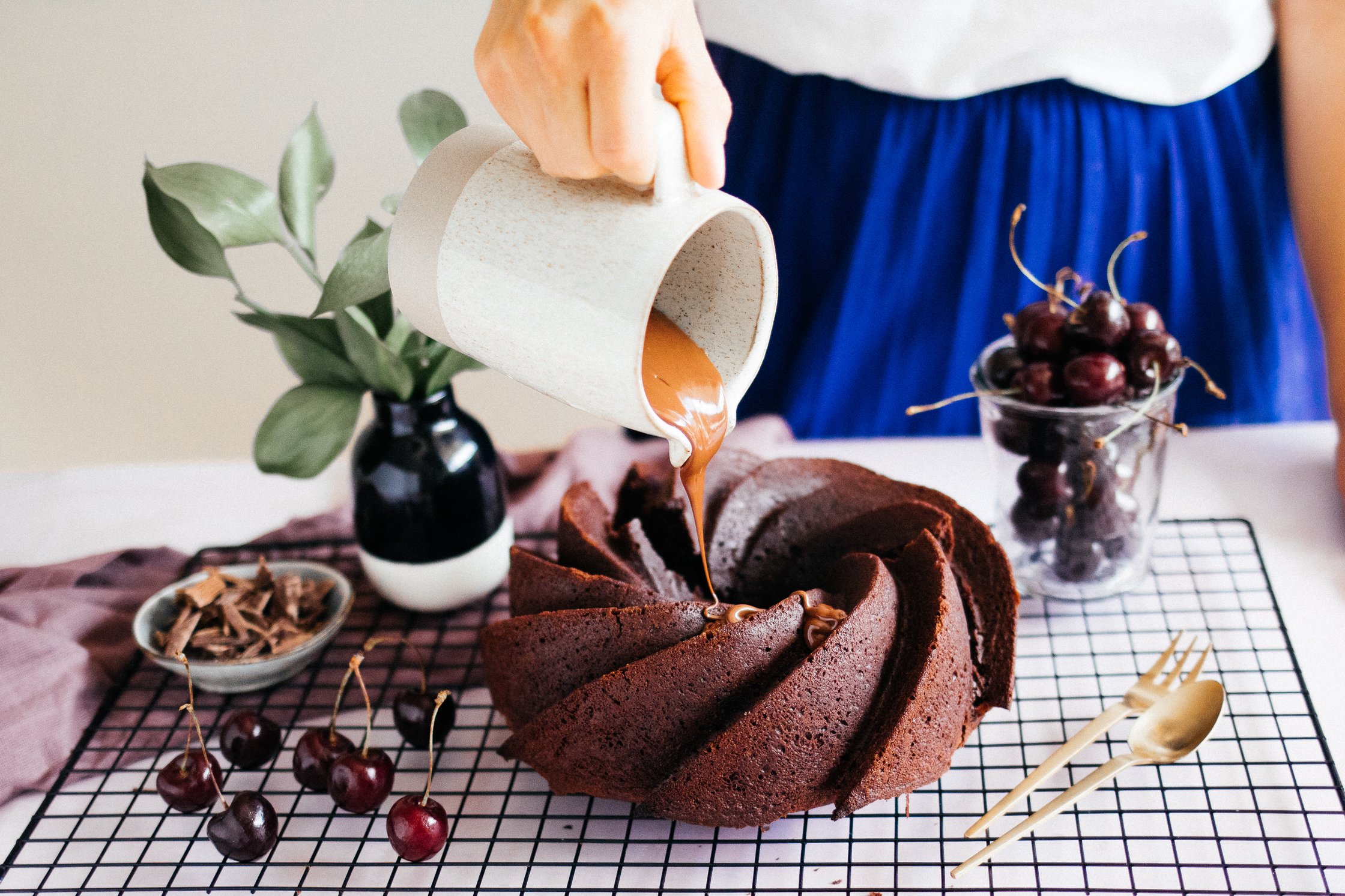 pouring melted chocolate on a vegan chocolate bundt cake