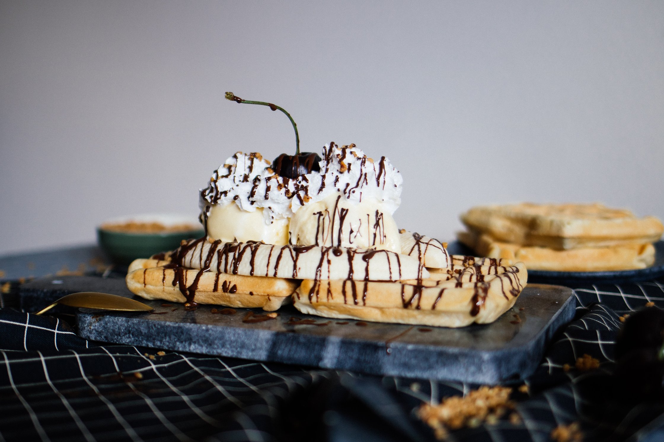 vegan banana split topped with chocolate sauce