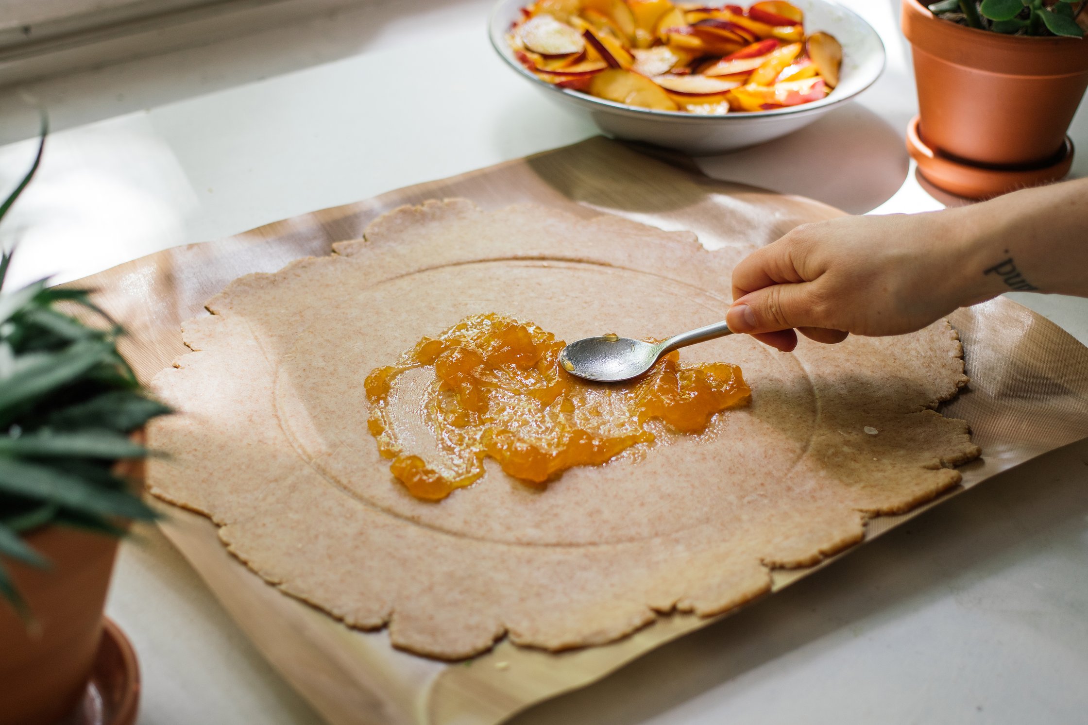 spreading jam on vegan galette