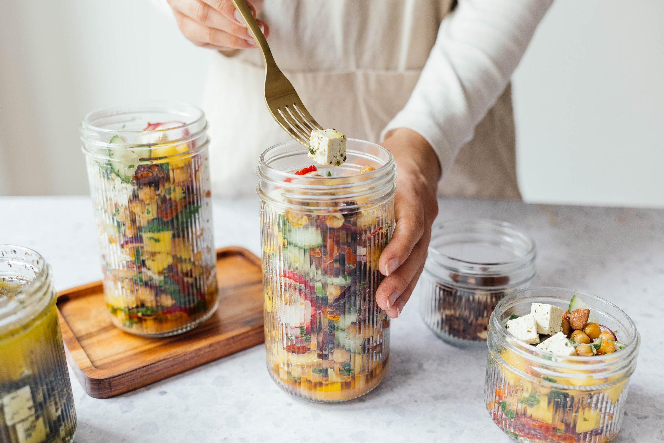 summer chickpea salad with vegan “feta heese“ filled in tall glasses