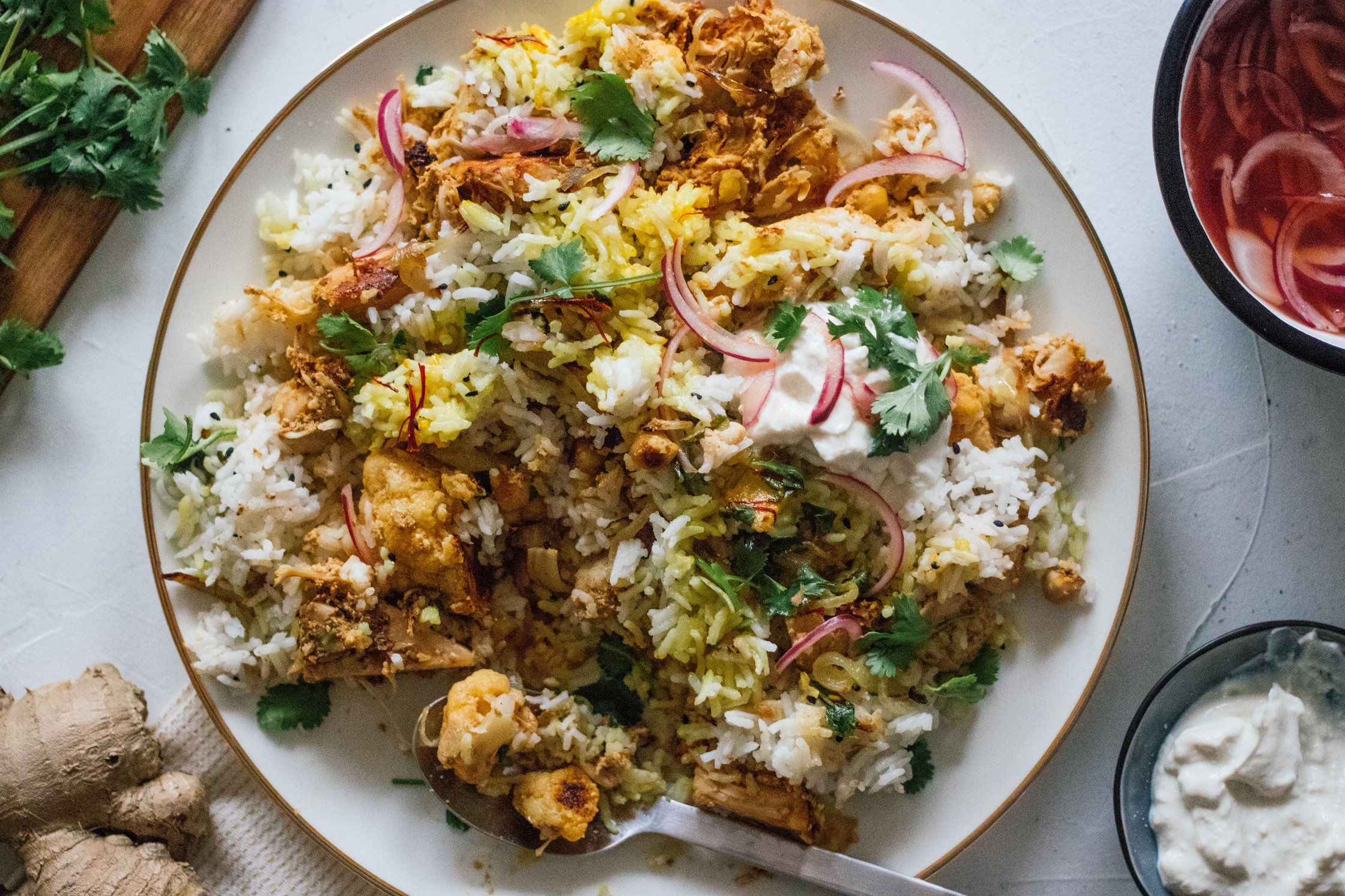 Vegan Jackfruit Biryani served with toppings of pickled onions and plantbased yogurt