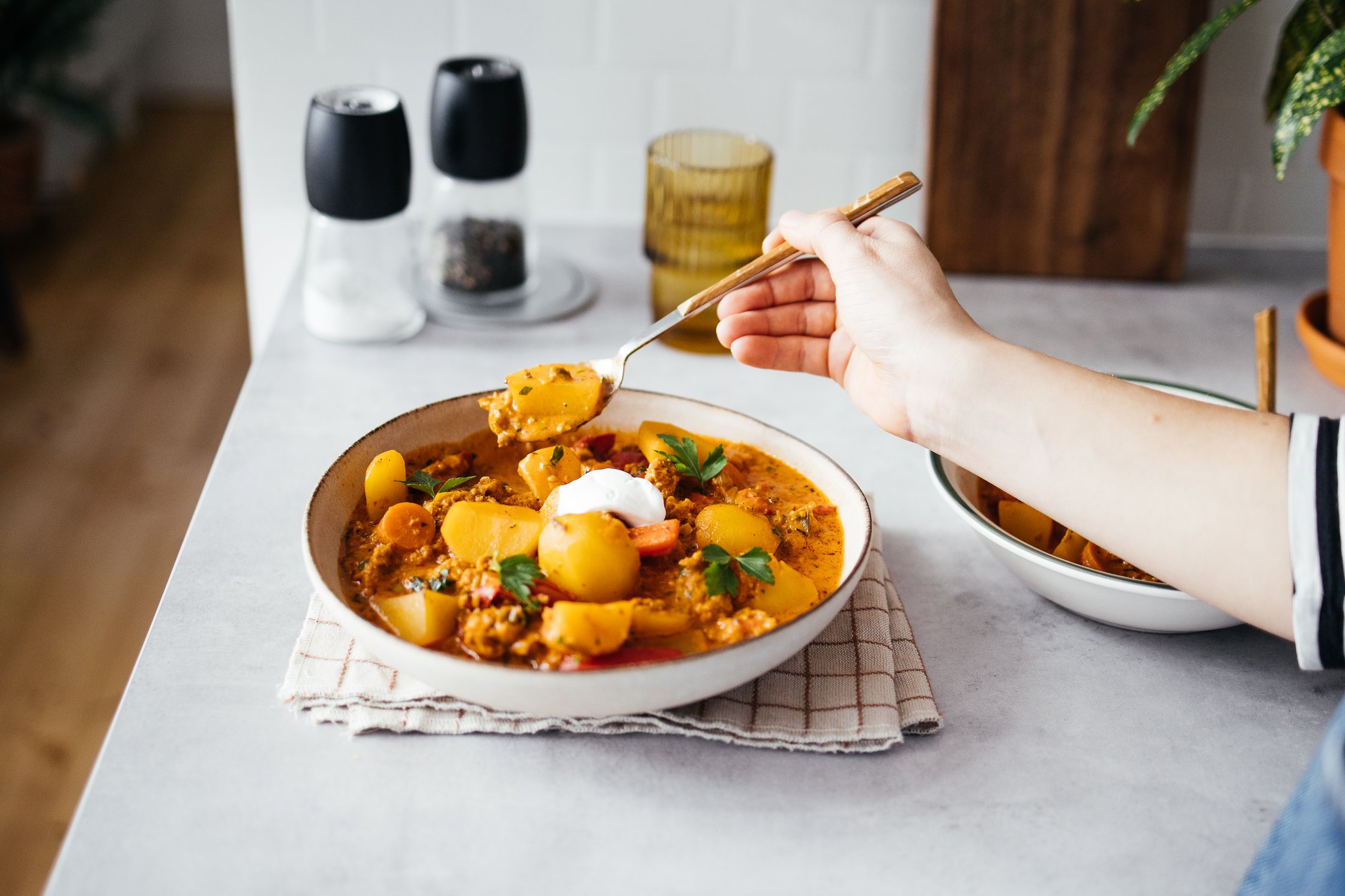 Isa eating a vegan stew