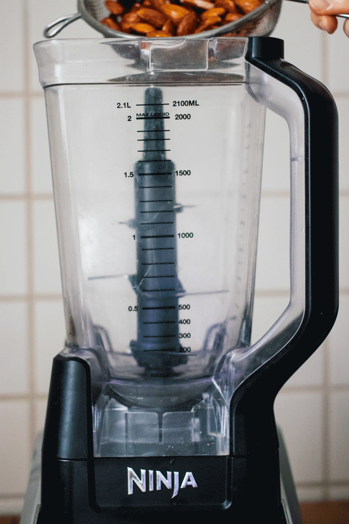 almonds and water get mixed in the processor