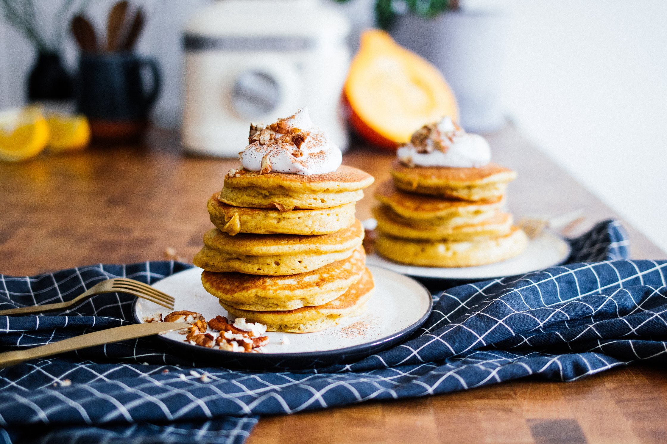 vegan pumpkin pancakes with whipped cream and cinnamon