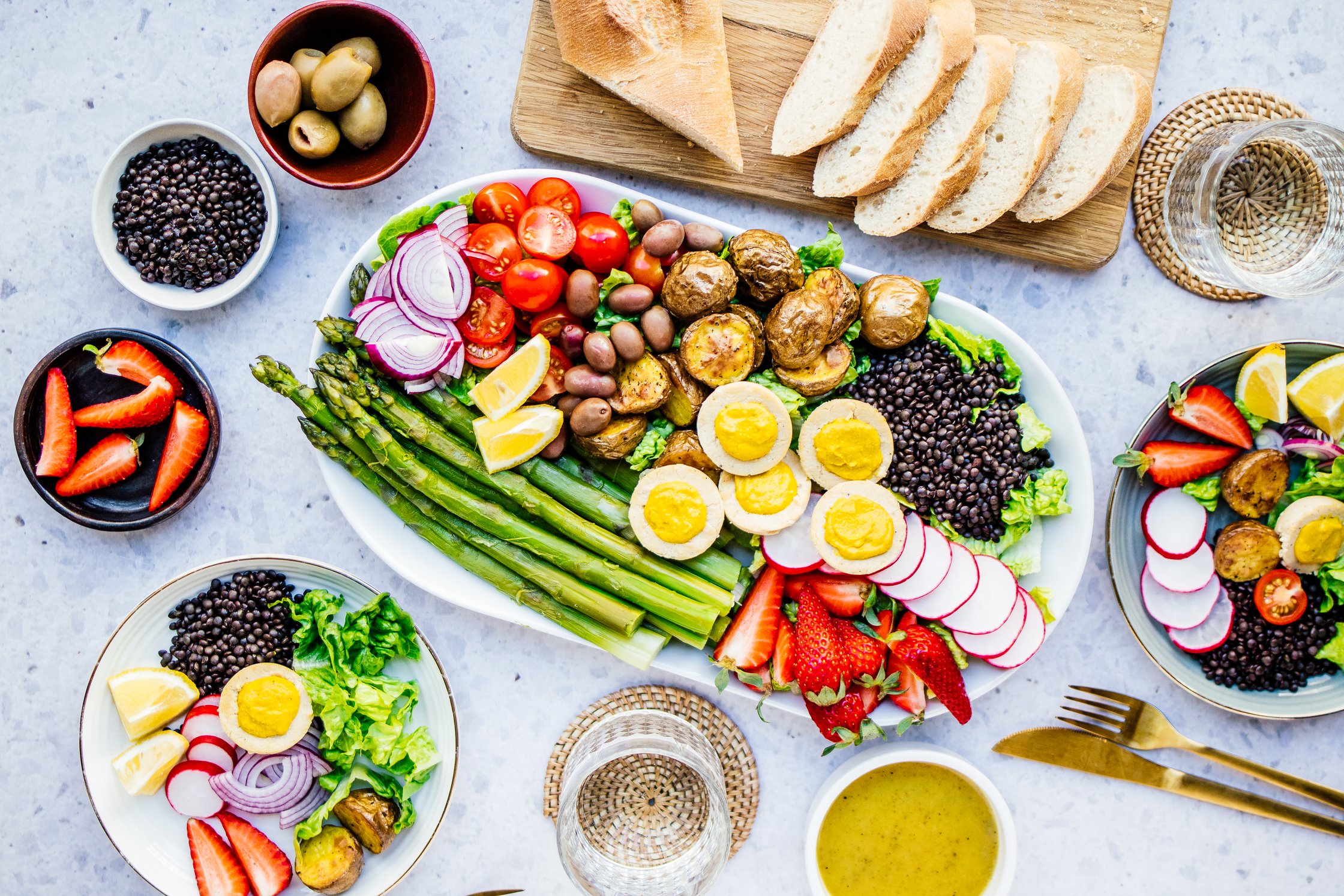 Vegan Salad with Asparagus, Baguette, Glasses and Cutlery