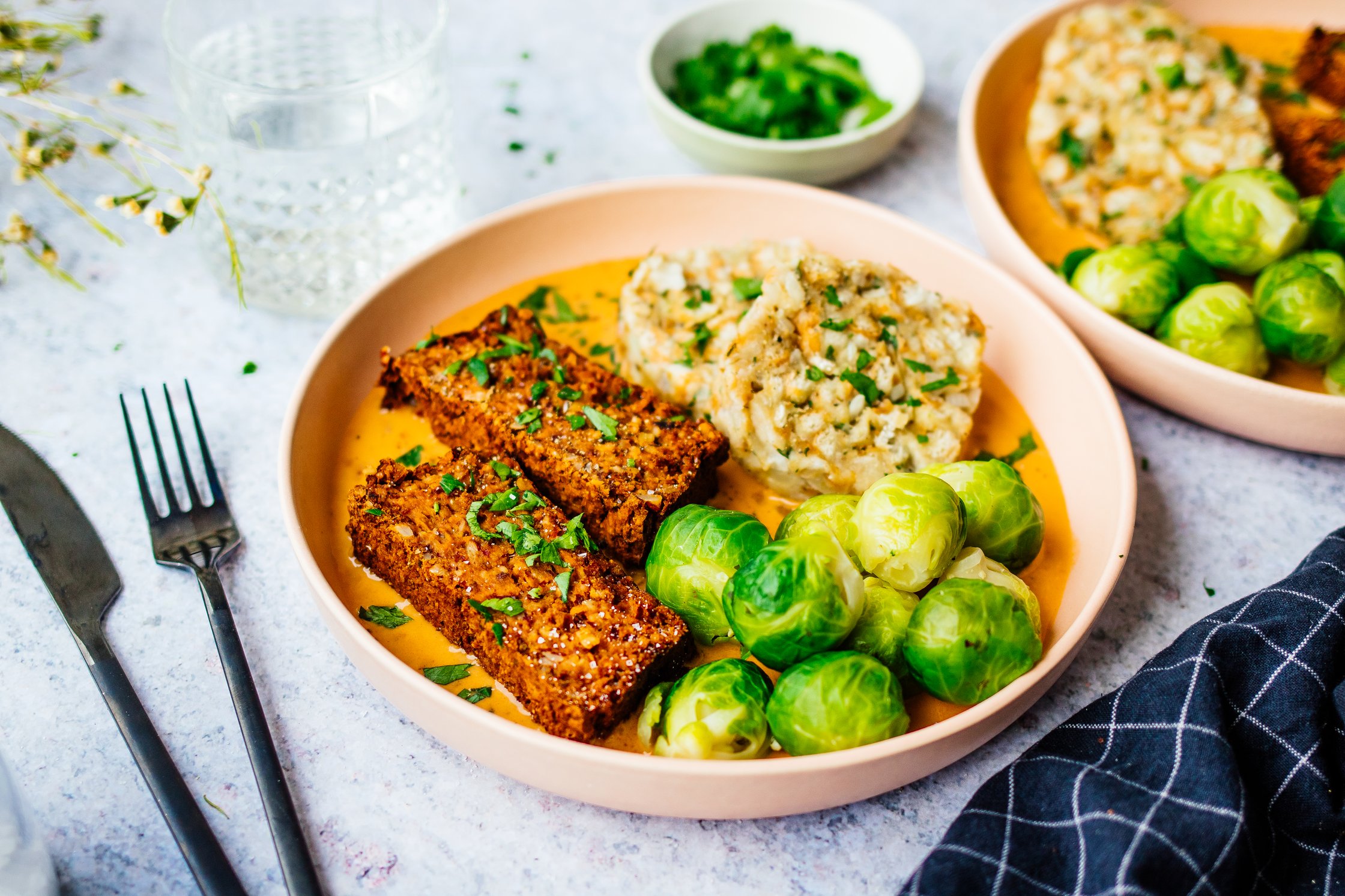 vegan nut roast with bread dumplings and brussels sprouts on a plate