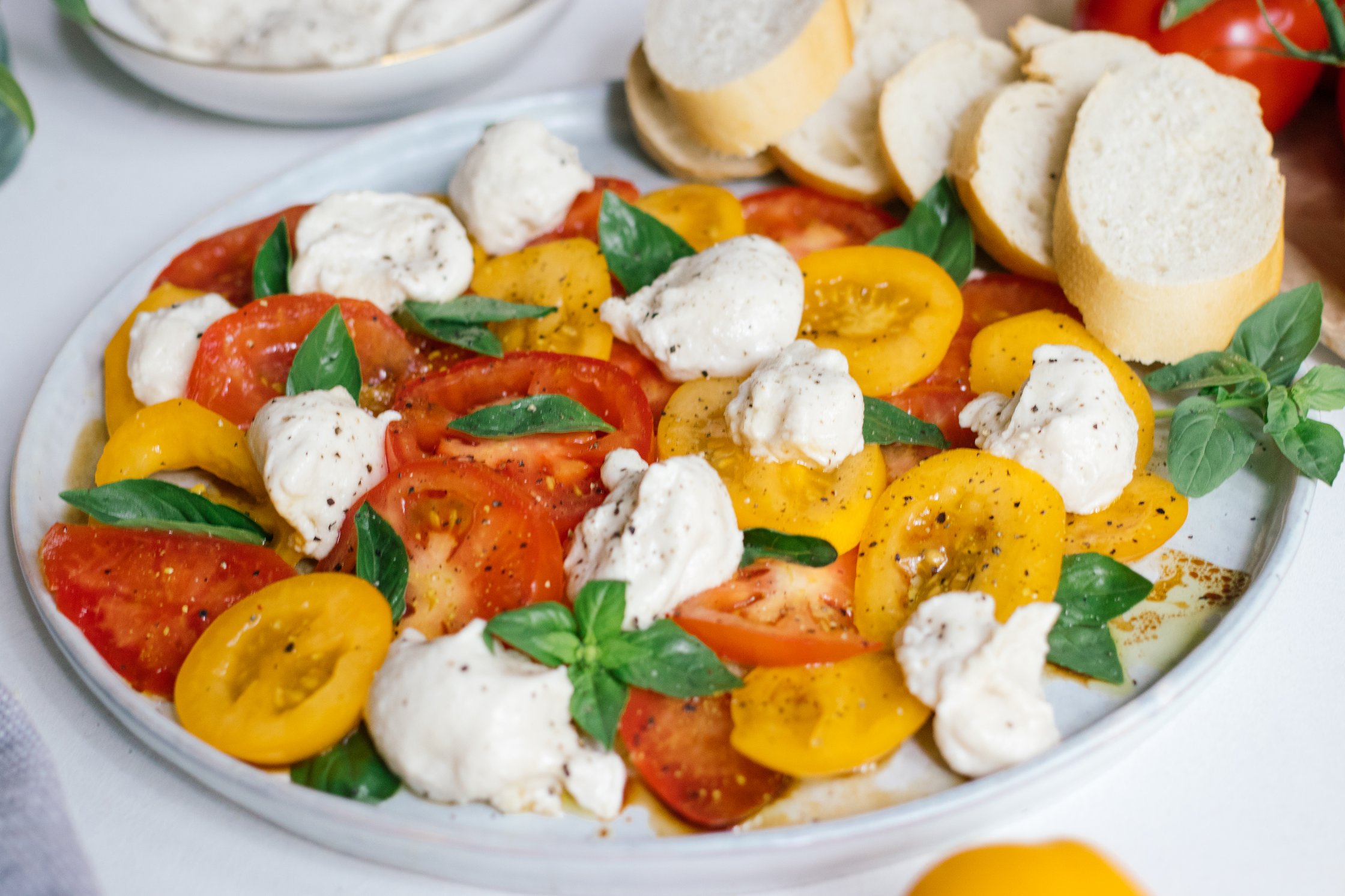 closeup of vegan caprese salat with homemade vegan mozzarella cheese