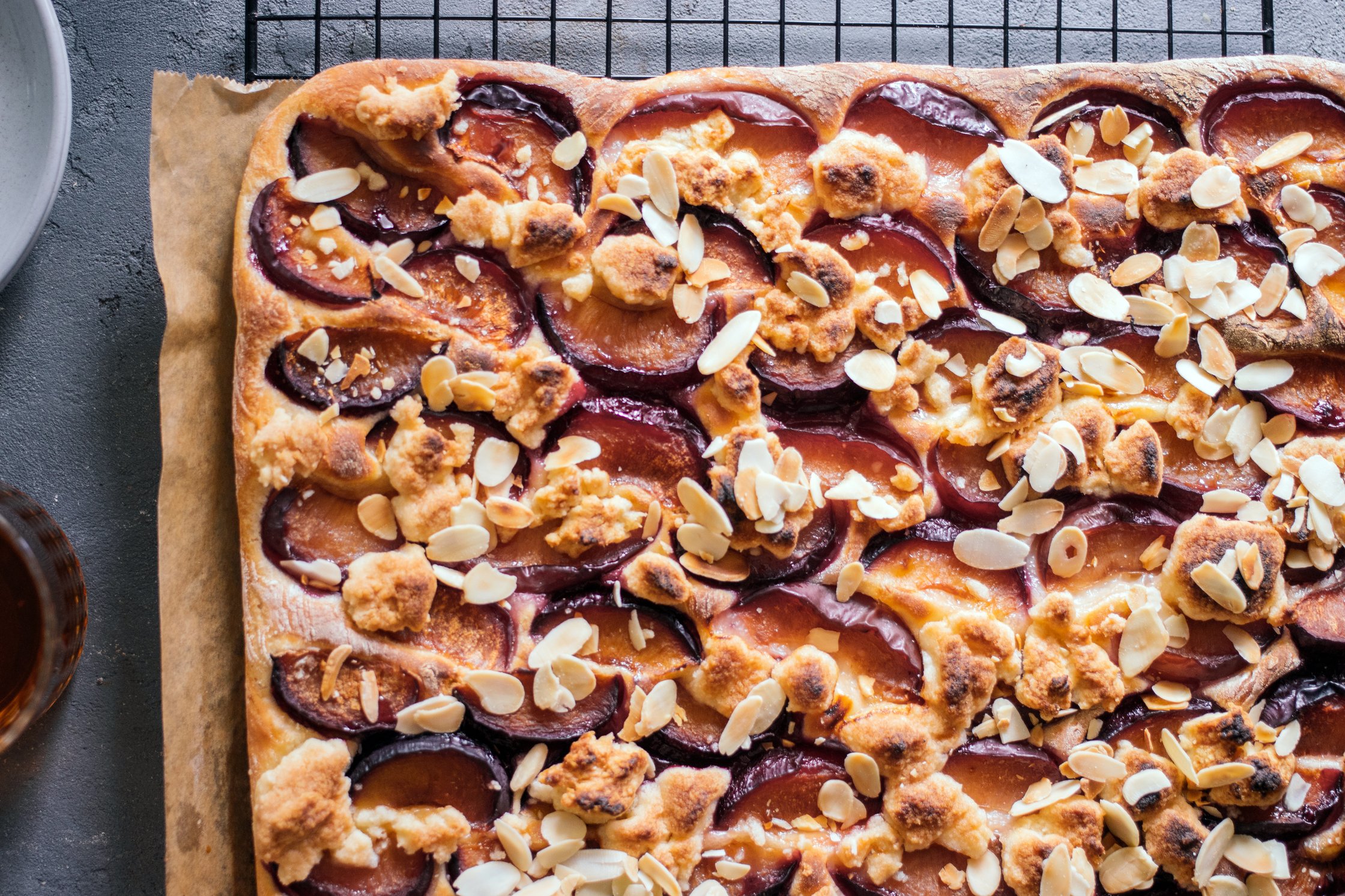 closeup of vegan Sheetpan Plum Cake with Yeast Dough and Crumble Topping