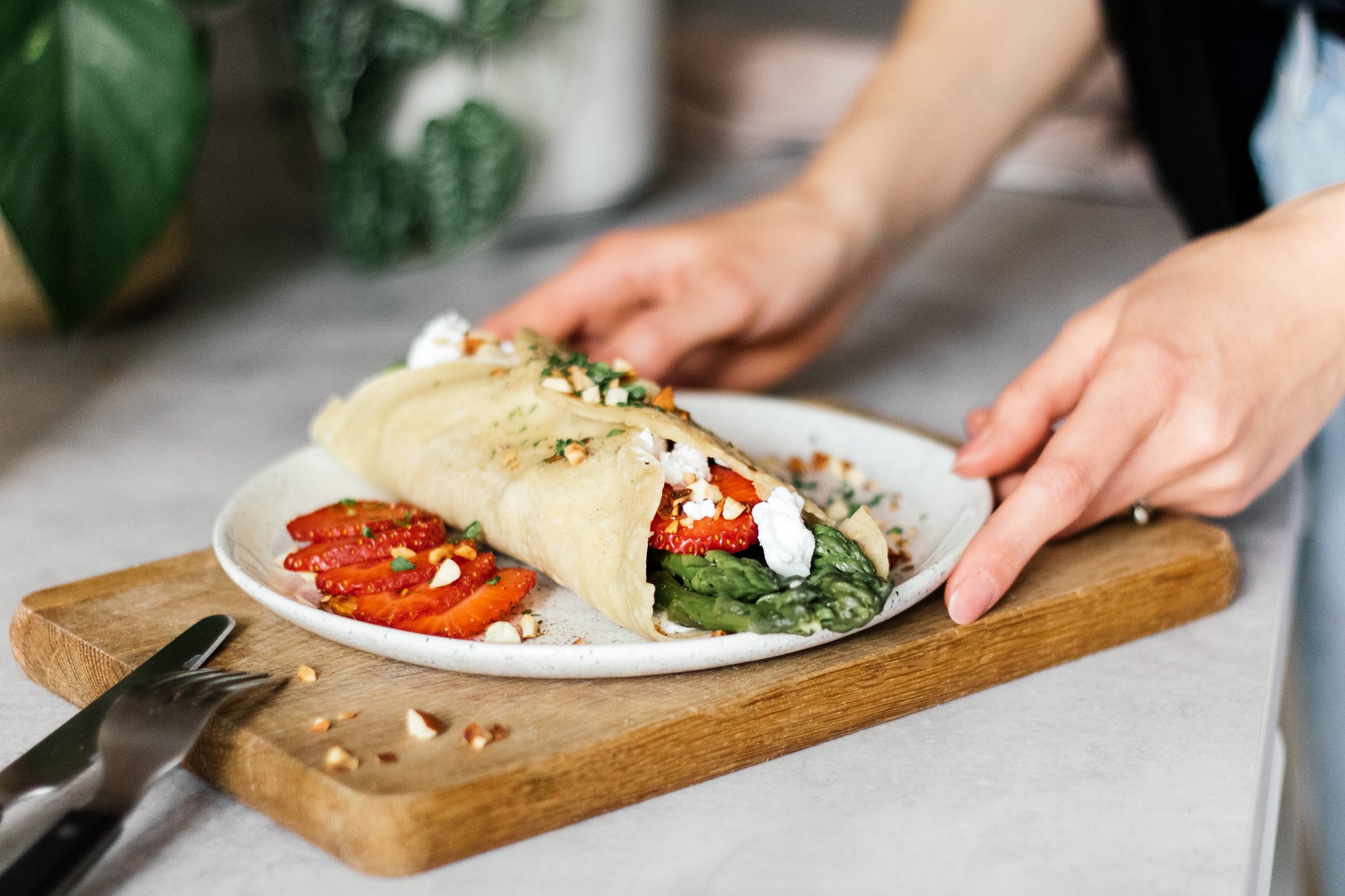 serving vegan pancakes with asparagus filling