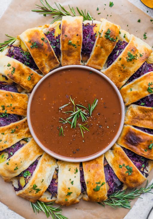 Vegan Puff Pastry Wreath Filled with Potato Dumplings, Red Cabbage & Plant-Based Sausages