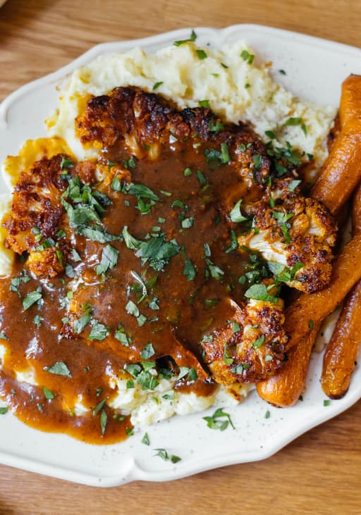 Baked Cauliflower with Mashed Potatoes, glazed Carrots and Vegan Gravy
